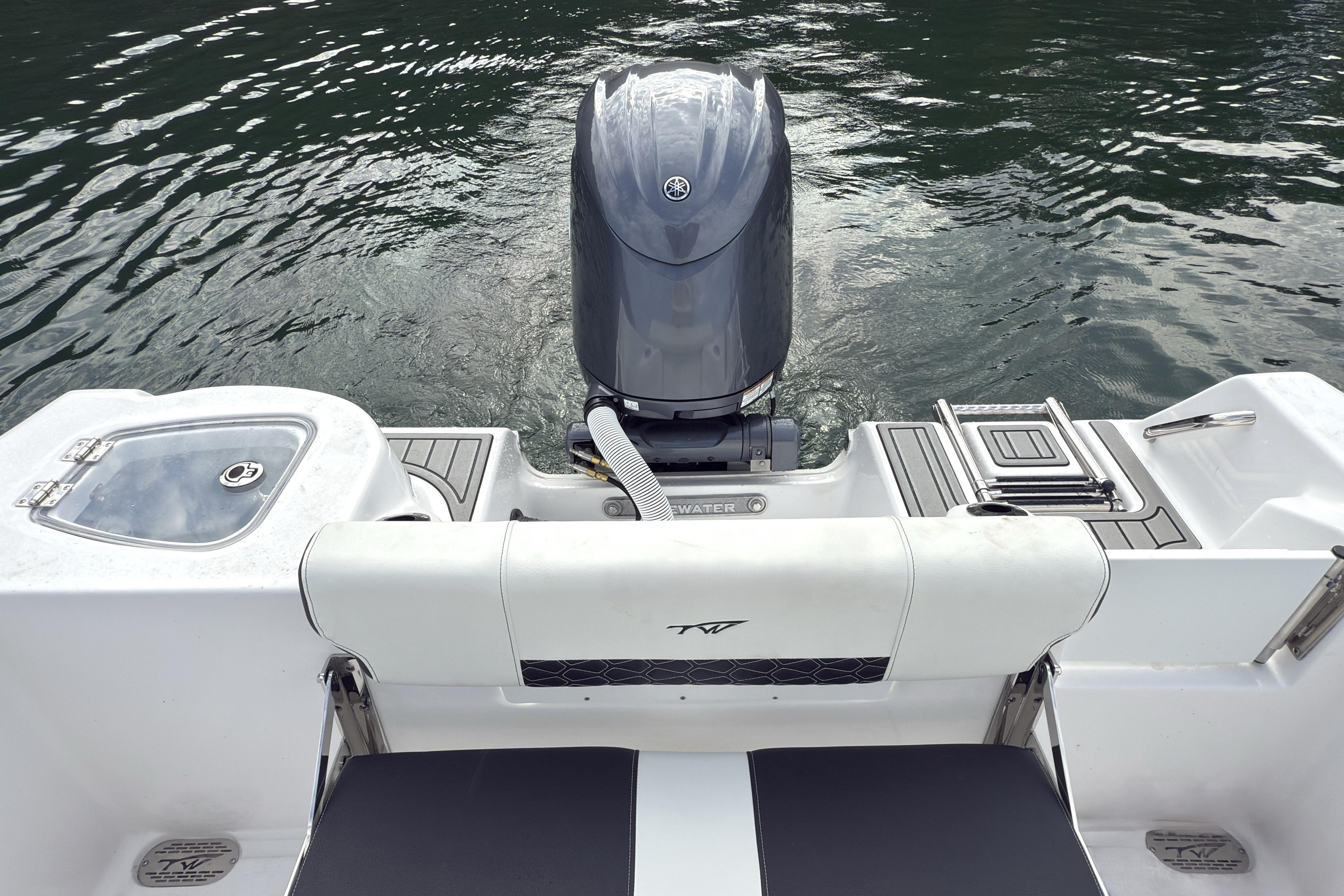 2026 Tidewater 210 CC Adventure boat with outboard motor on calm water.