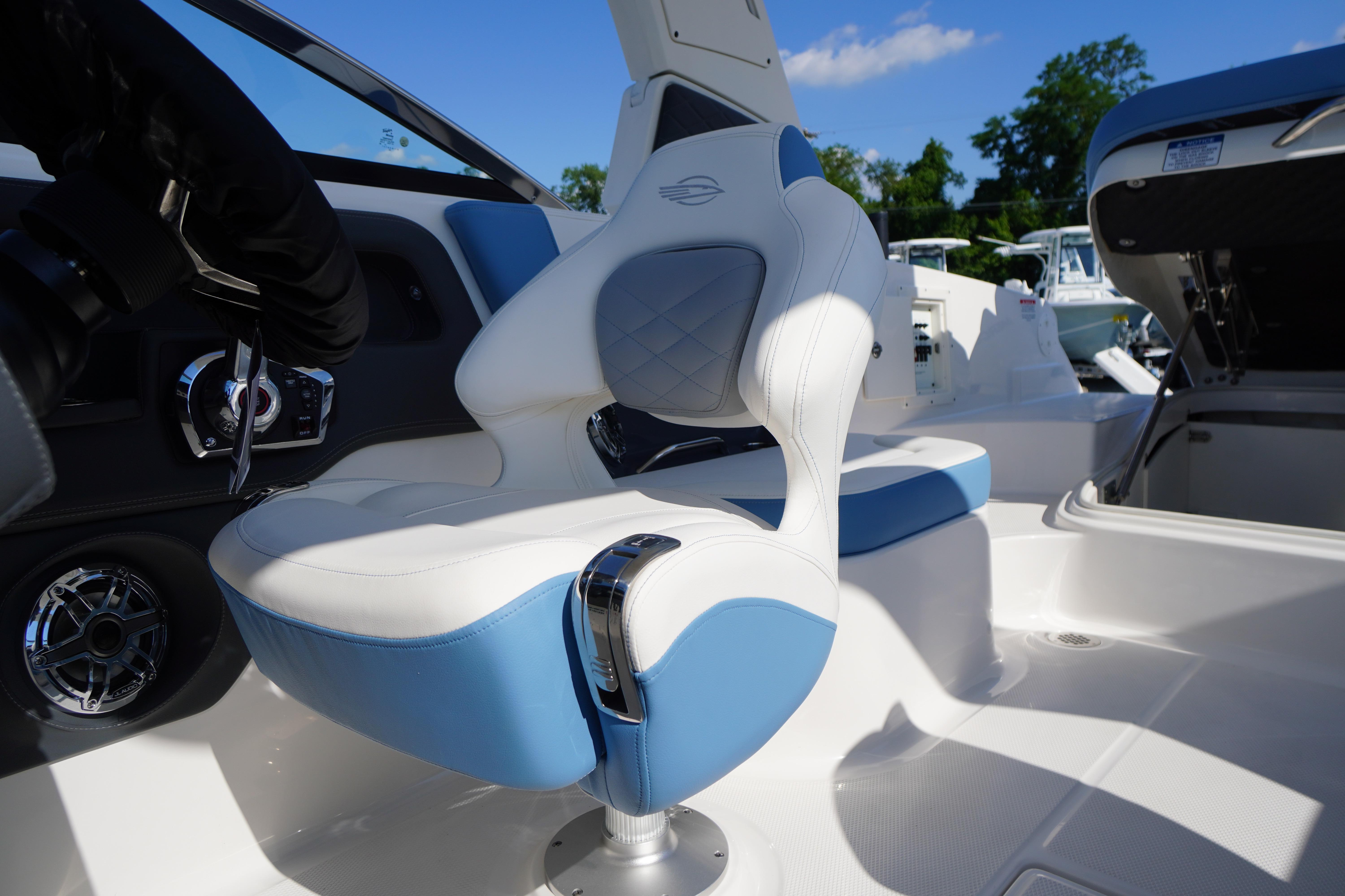 Luxury seating in the 2026 Chaparral 270 OSX boat, featuring blue and white upholstery.