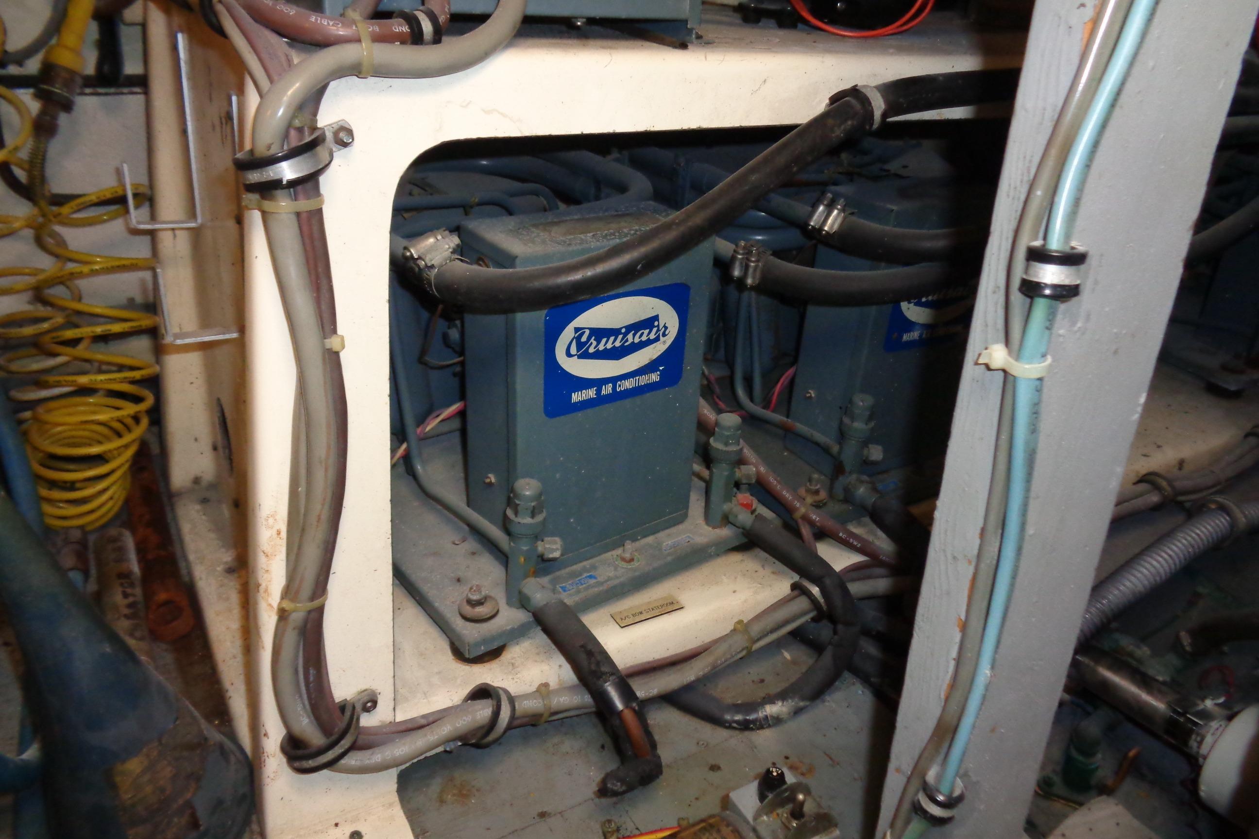 Engine room of 1981 Hatteras 48 Cockpit Motor Yacht with Cruisair marine air conditioning unit.