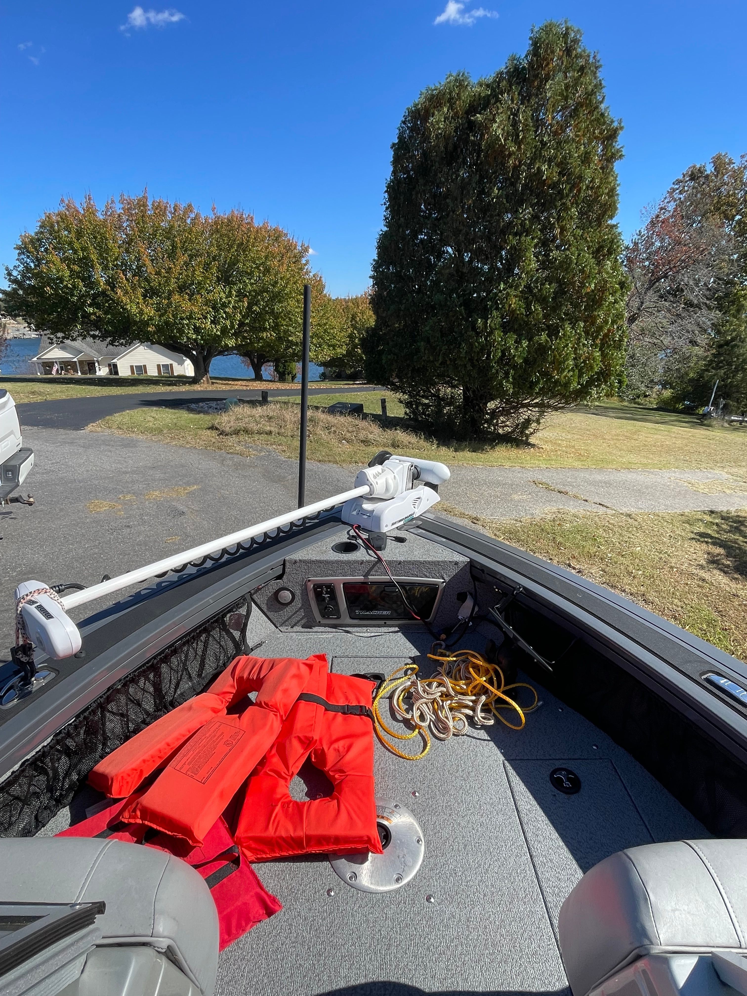 2017 Bass Tracker TARGA boat with life jackets and ropes, parked in a scenic setting.