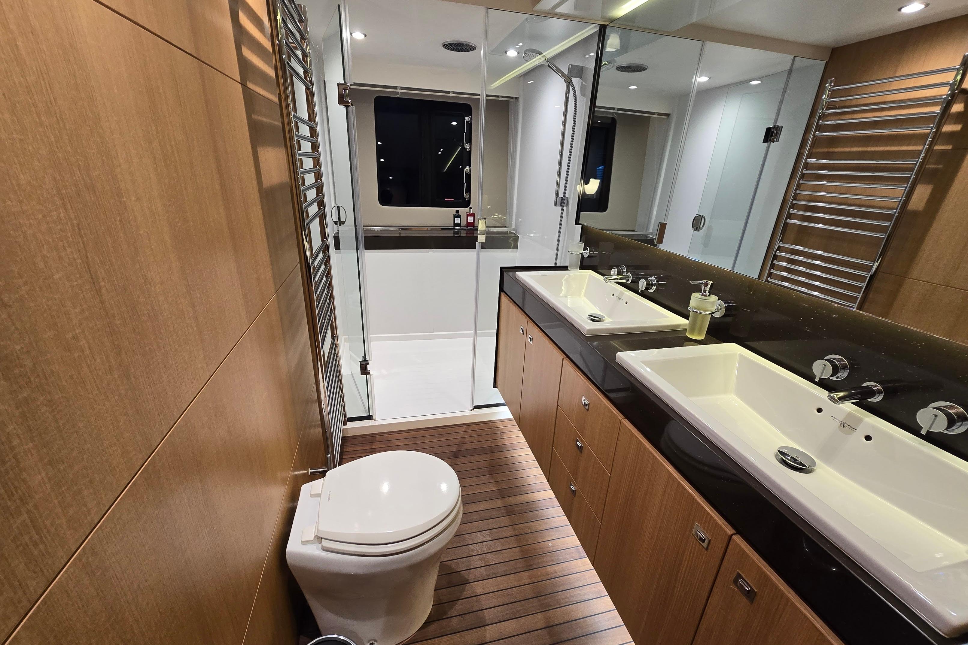 Luxurious bathroom on 2011 Princess 72 yacht with dual sinks and modern shower.