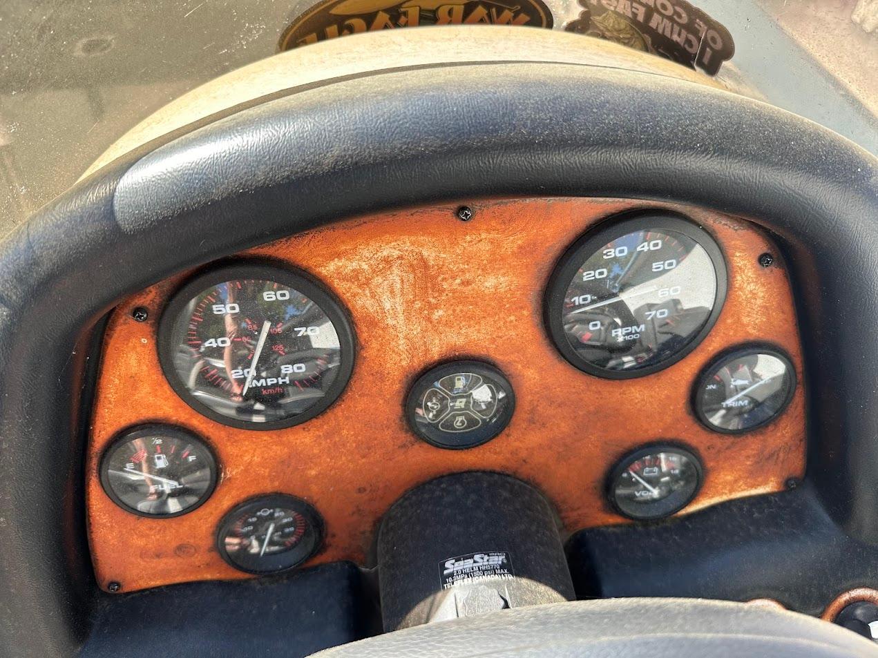 Dashboard of a 1999 Fisher 21 FX DC boat with speedometer and gauges.
