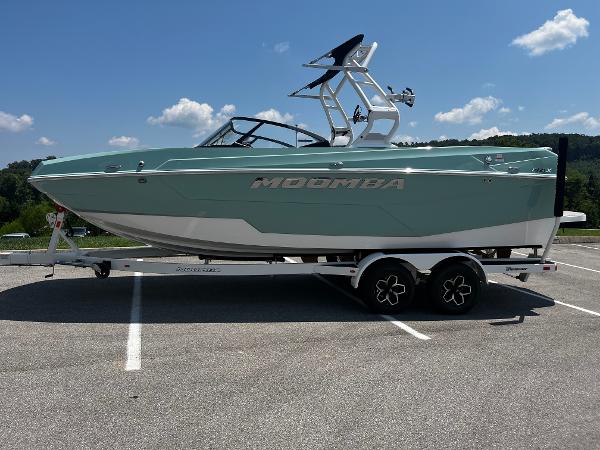 2025 Moomba Max boat on trailer in parking lot, sunny day.