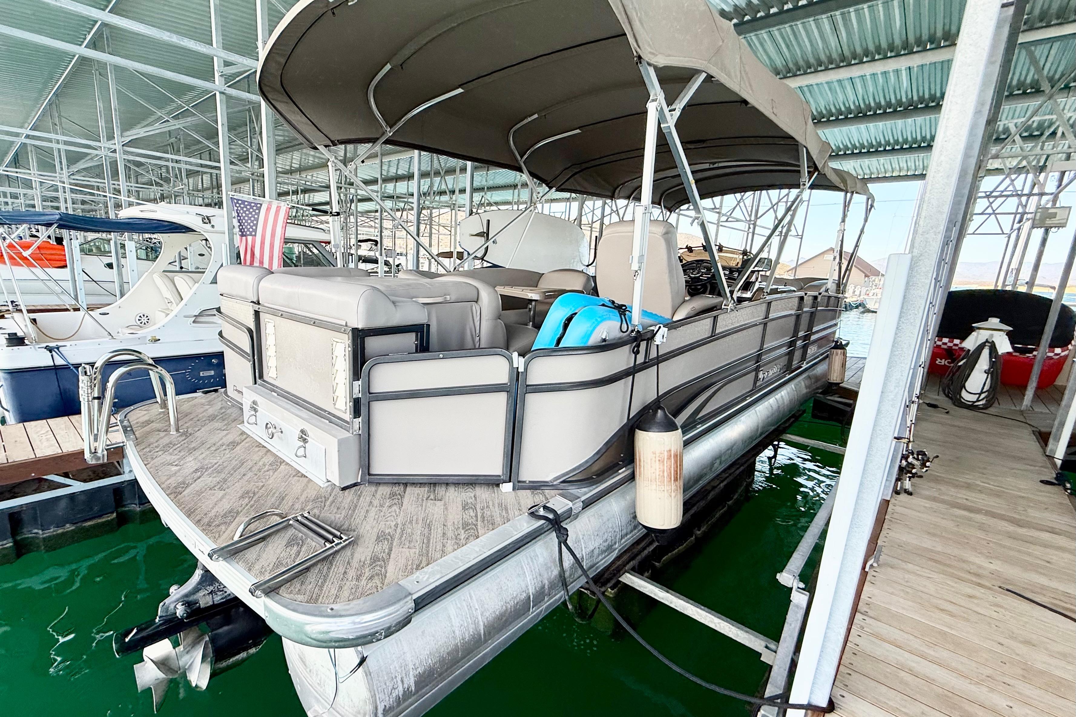 2011 Premier 275 Grand Majestic PTX pontoon boat docked in a marina.