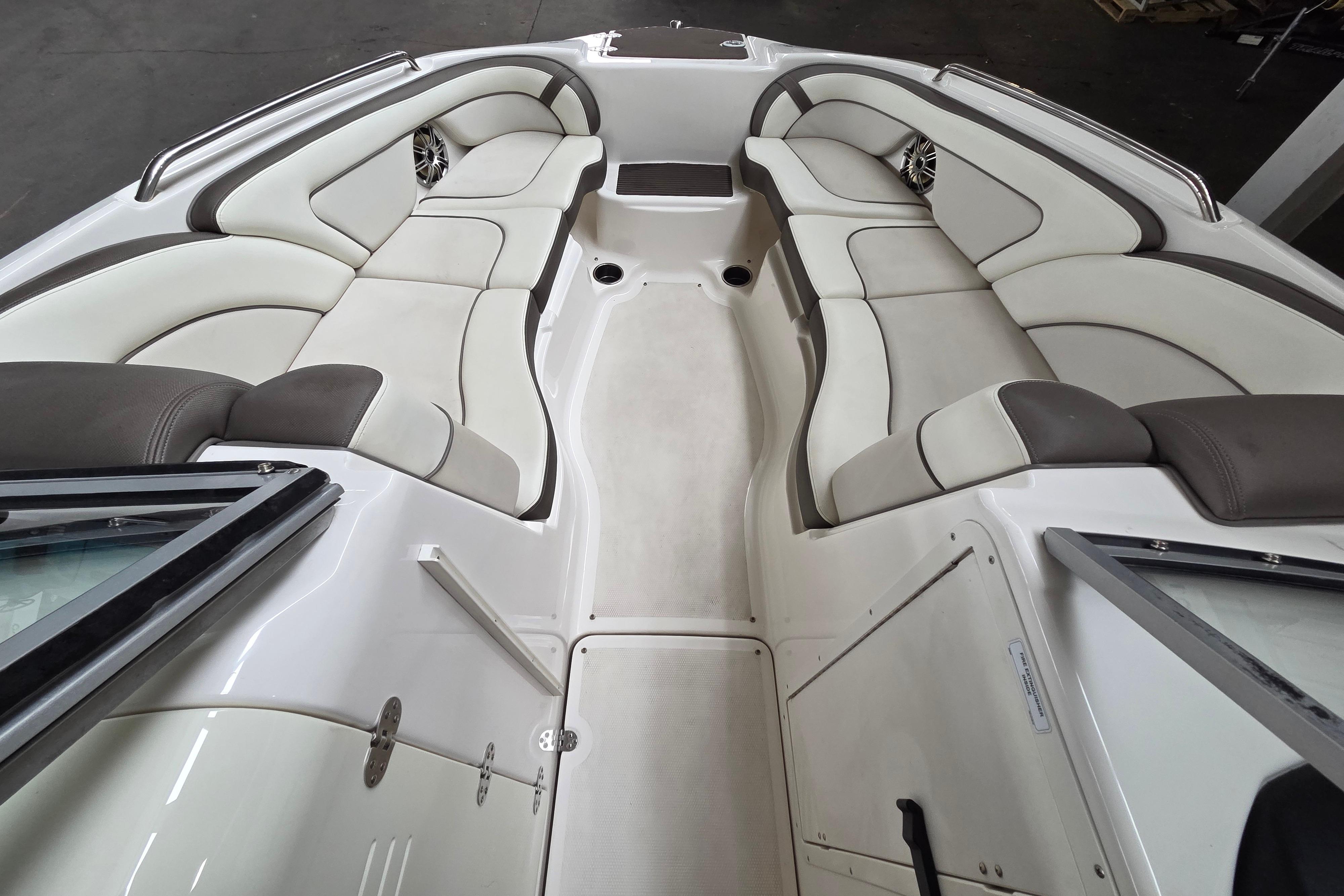 Interior of a 2013 Yamaha 242 Limited S boat with white and gray seating.