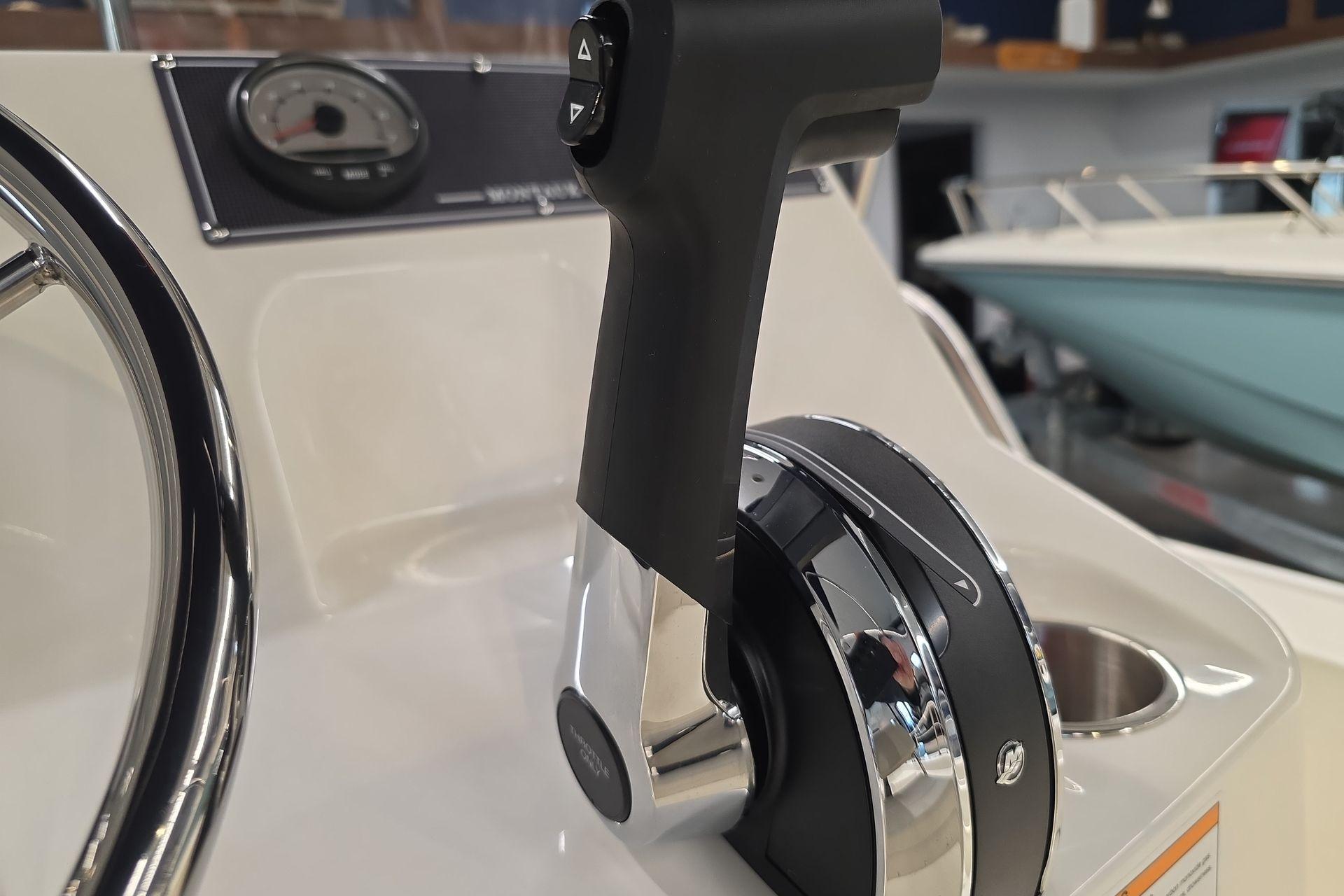 2026 Boston Whaler 150 Montauk throttle control and steering wheel close-up.