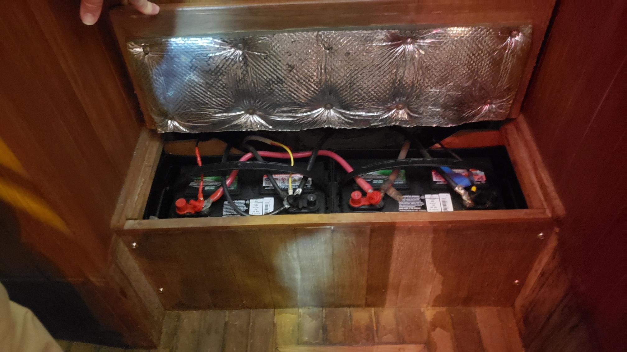 Battery compartment in a 1981 Shannon 28 boat with insulation and wiring.