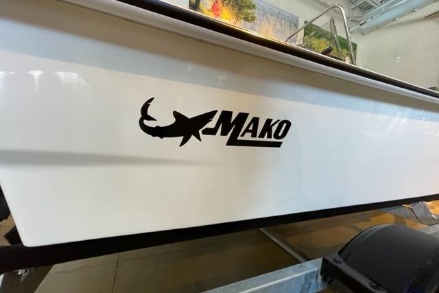 2026 Mako Pro Skiff 13 CC boat logo on white hull in showroom.