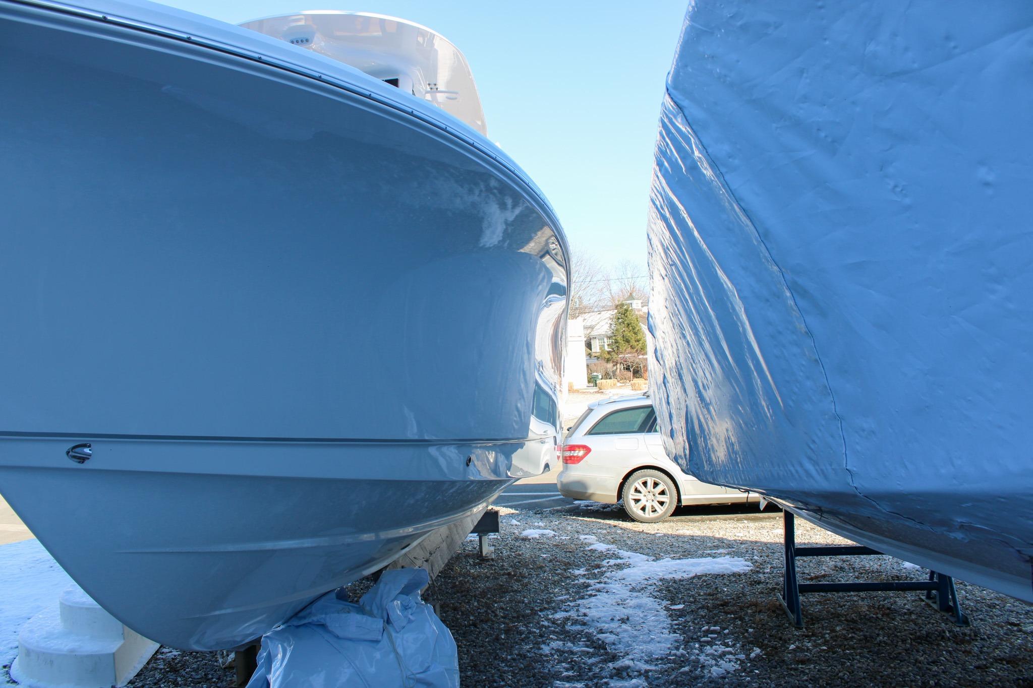 2026 Sea Hunt Gamefish 25 boats in storage, side view with protective covers.