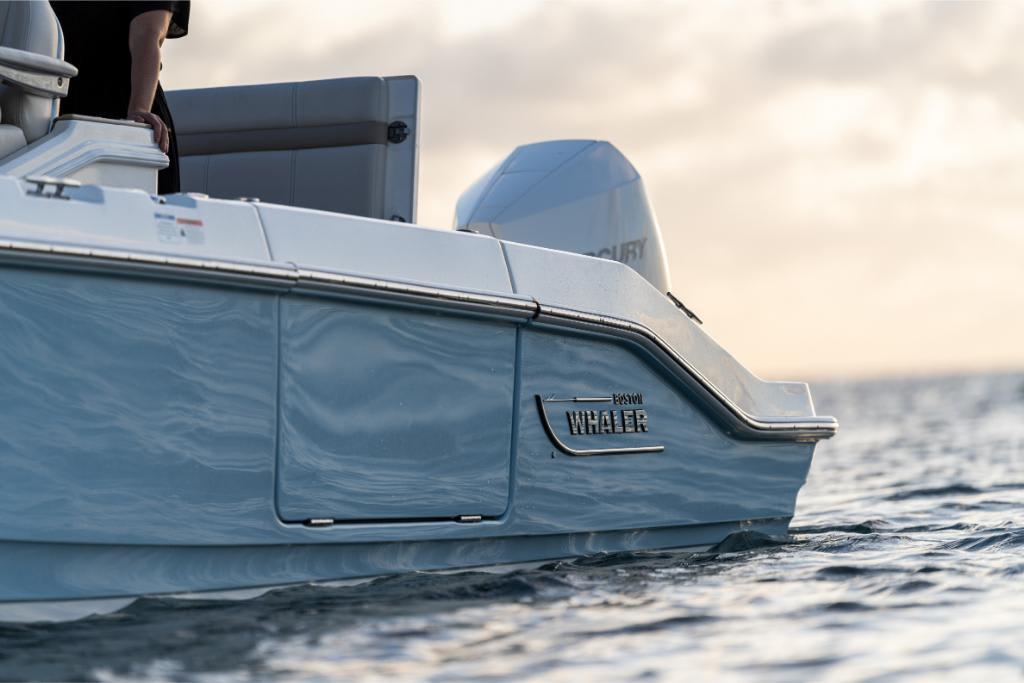 2024 Boston Whaler 280 Dauntless boat on water at sunset.