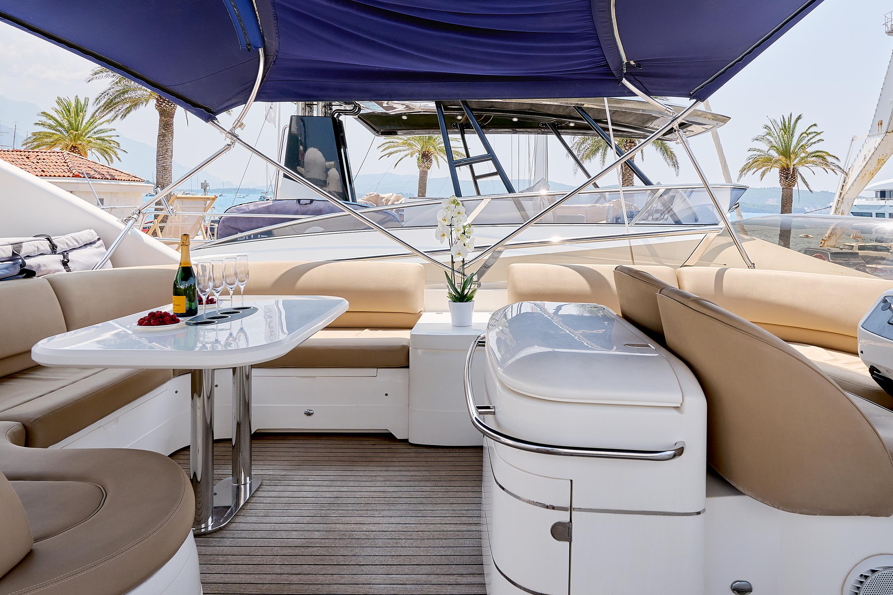 Luxurious 2009 Princess 23M yacht interior with elegant seating, table, and champagne setup.