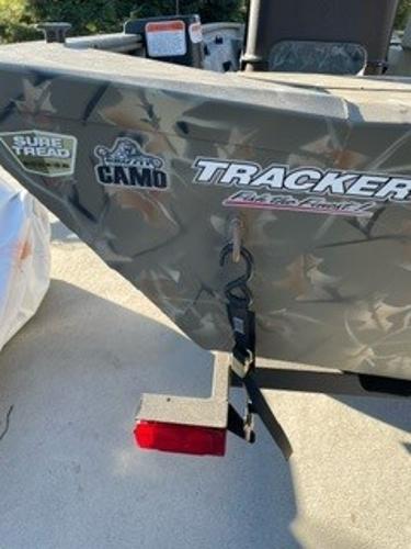 2024 Tracker Grizzly 1754 SC boat with camo design and decals.