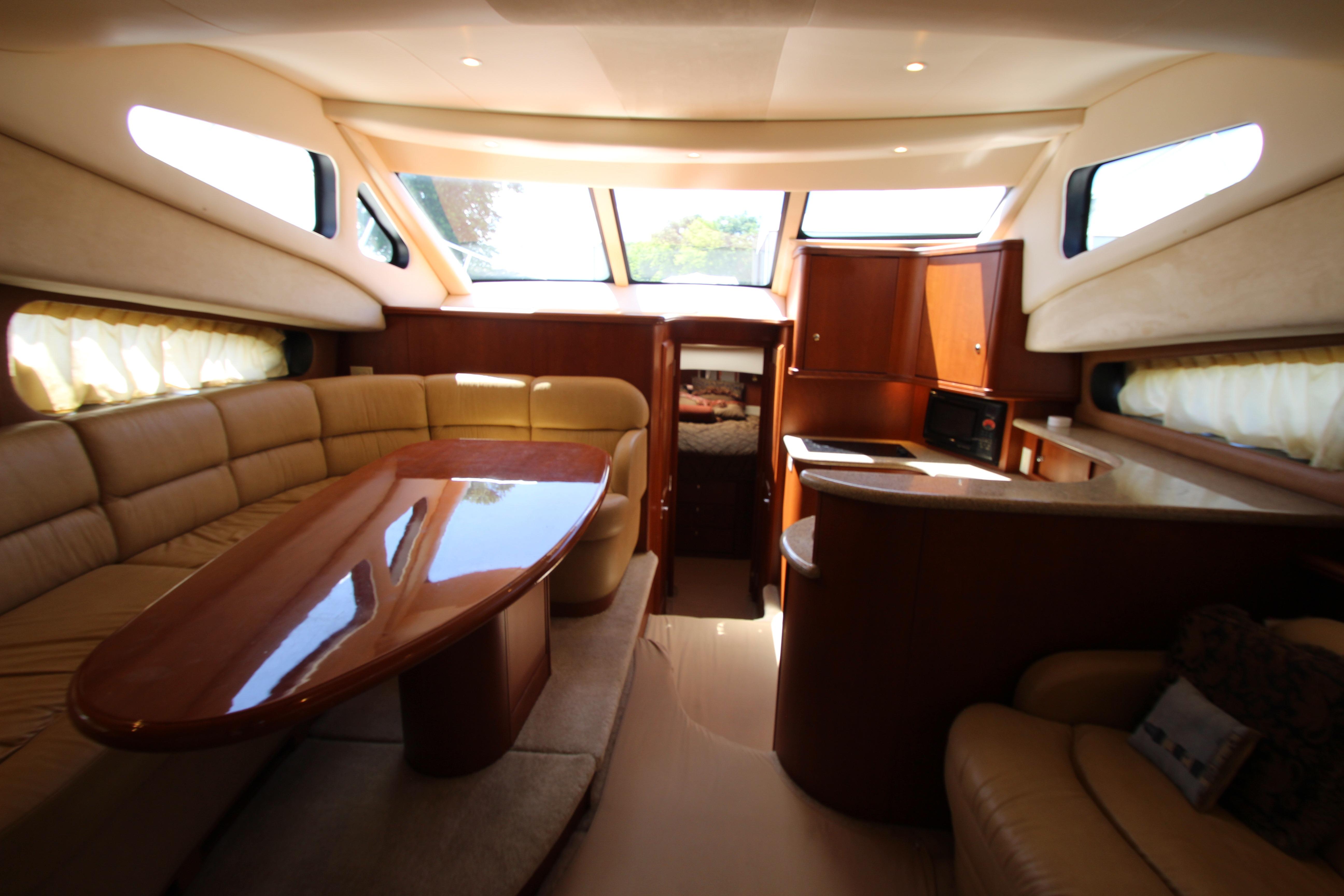 Luxurious interior of a 2006 Silverton 38 Sport Bridge yacht with elegant seating and dining area.