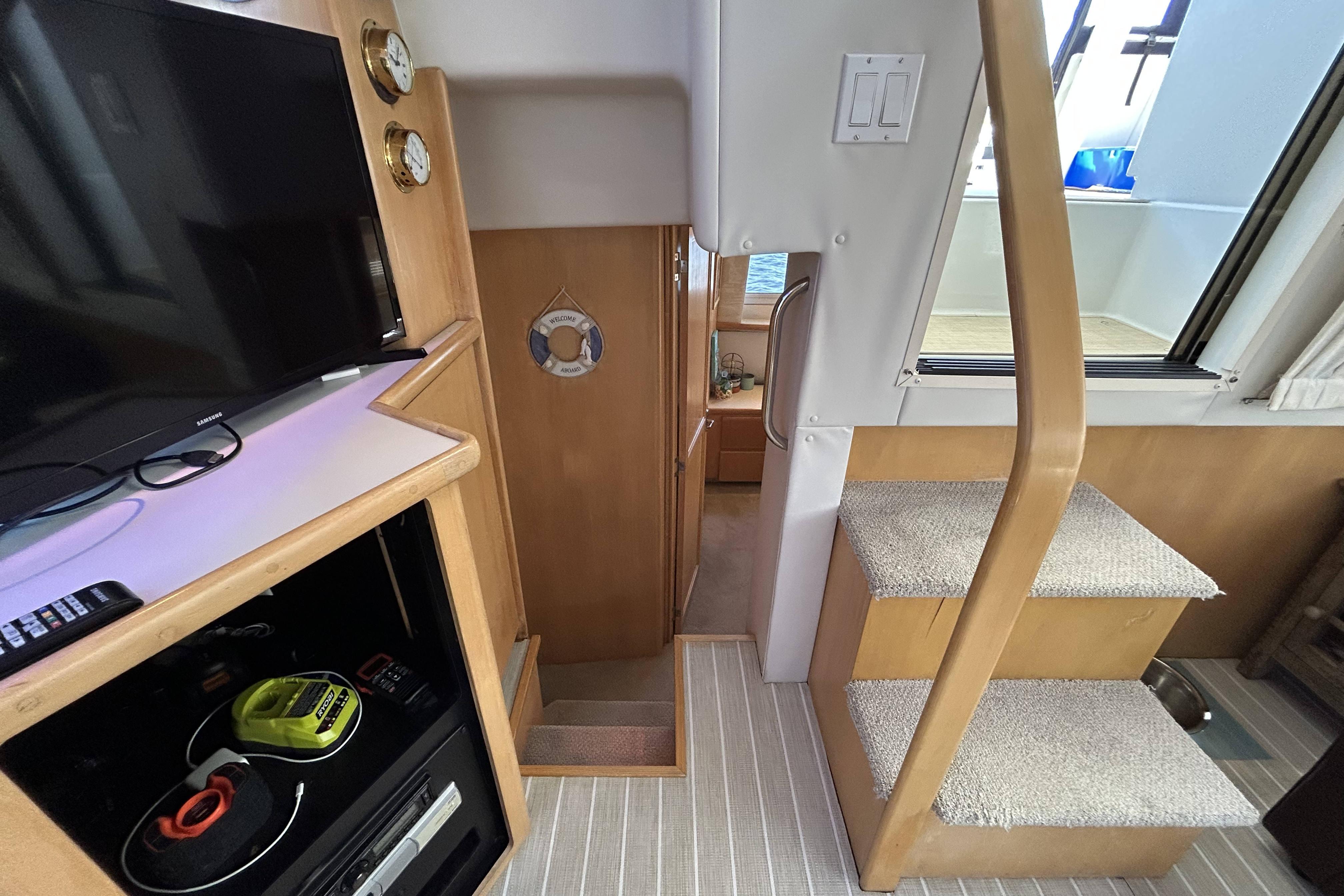 Interior of 1995 Carver 355 Aft Cabin Motor Yacht with stairs and entertainment area.