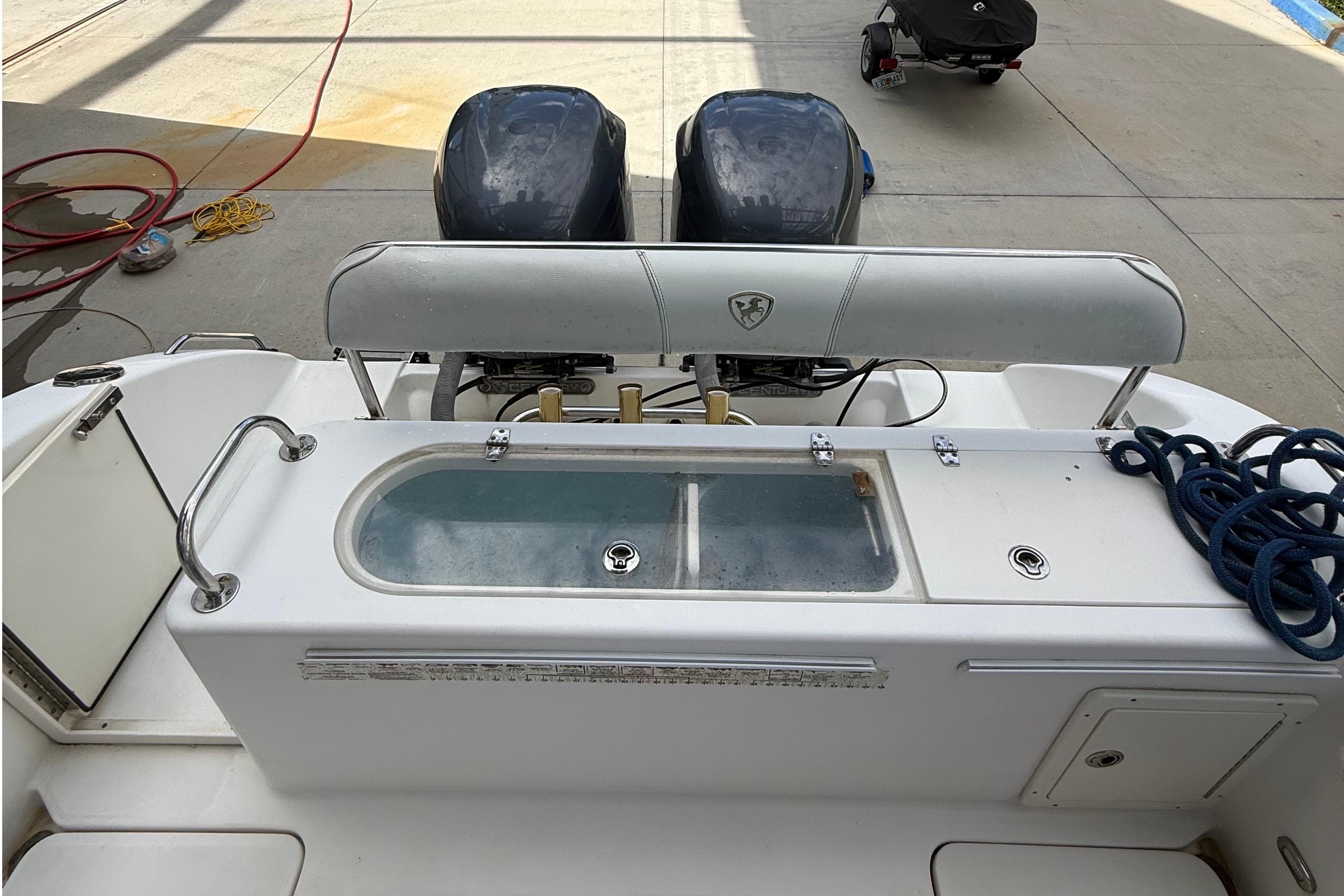 2008 Century 2901 Center Console boat with dual engines and fishing equipment.