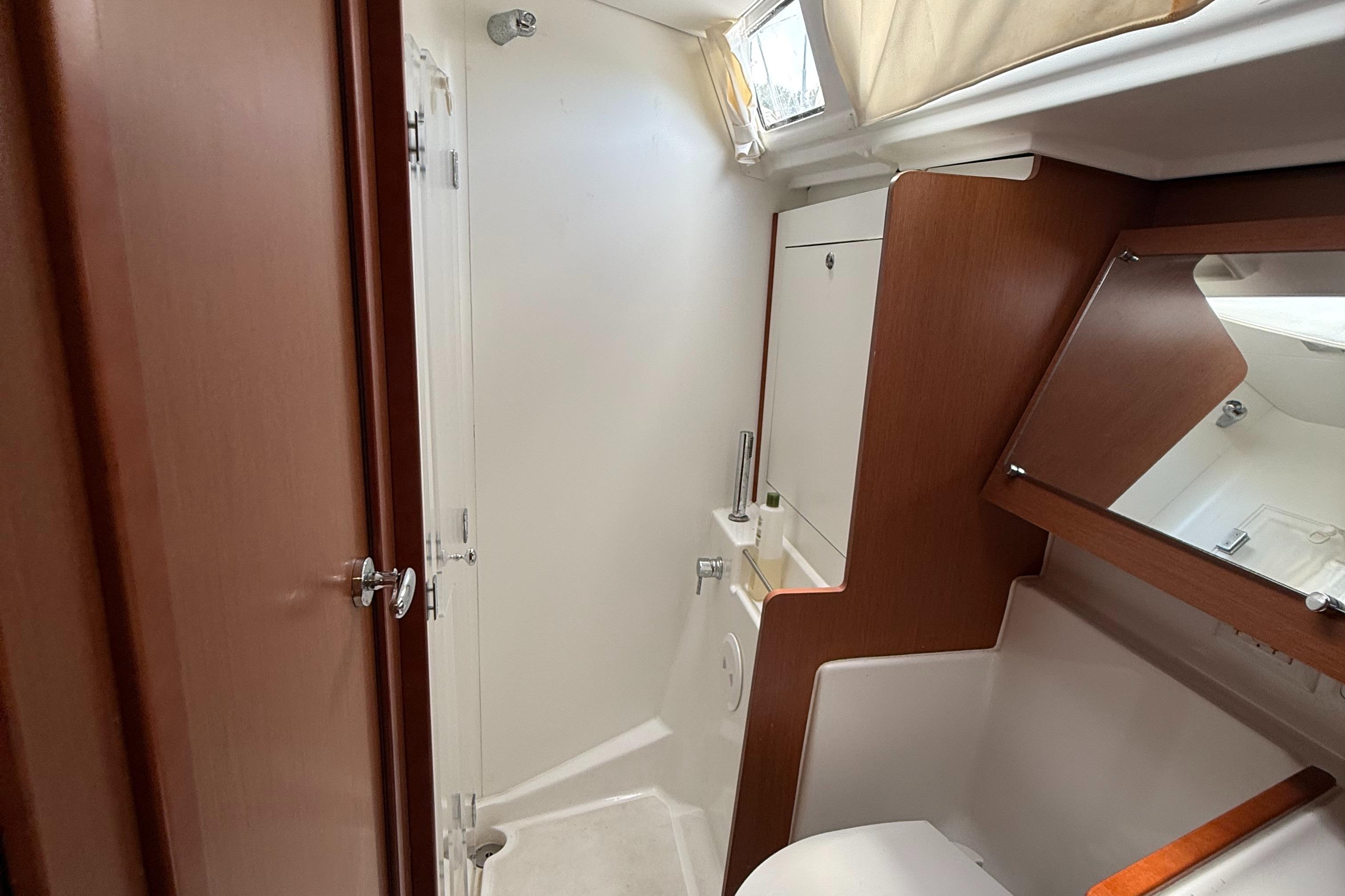 Interior of 2016 Beneteau Oceanis 45 yacht bathroom with wood accents and modern fixtures.