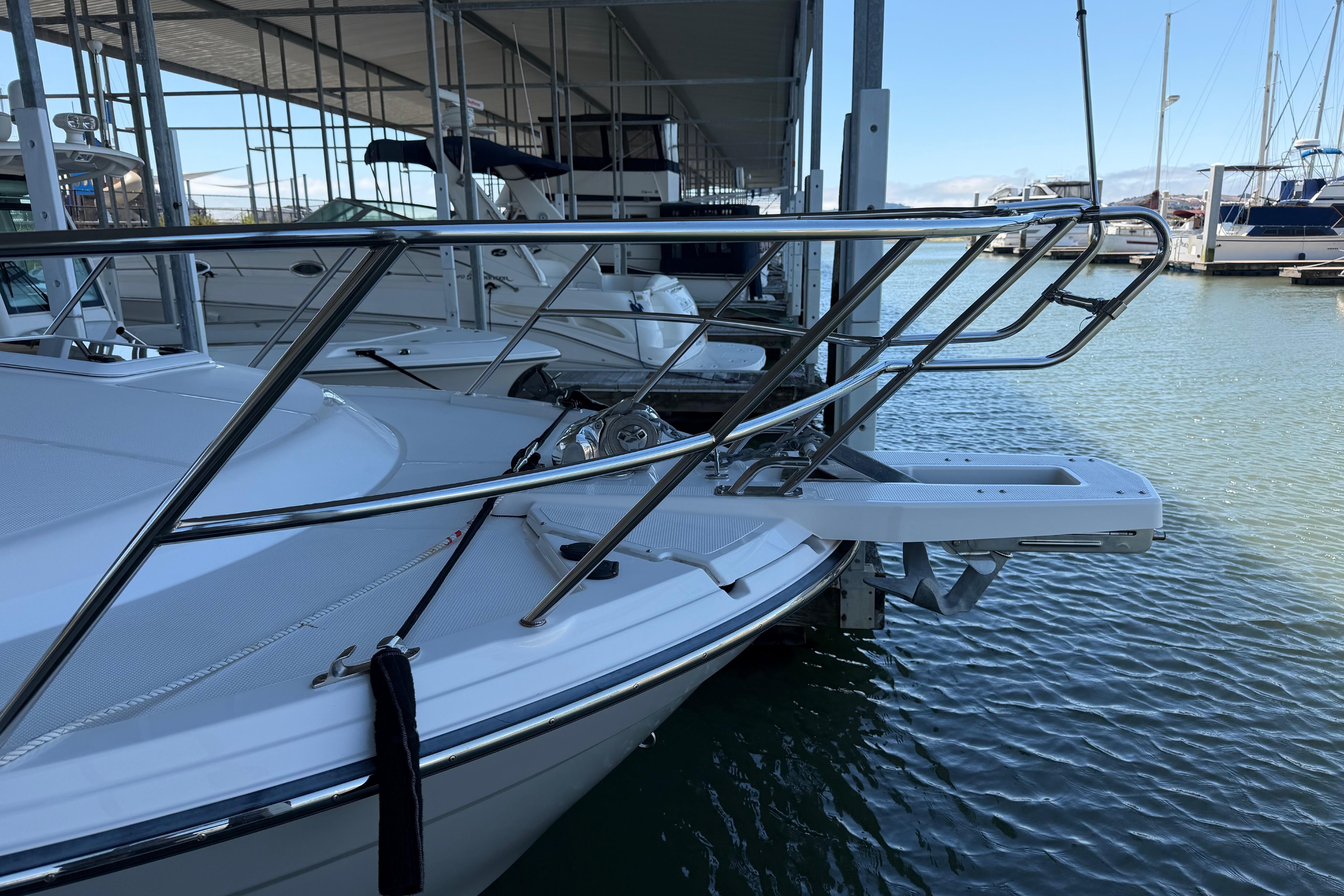 2023 Cutwater C-288 Coupe boat docked, showcasing sleek bow design and stainless steel railings.
