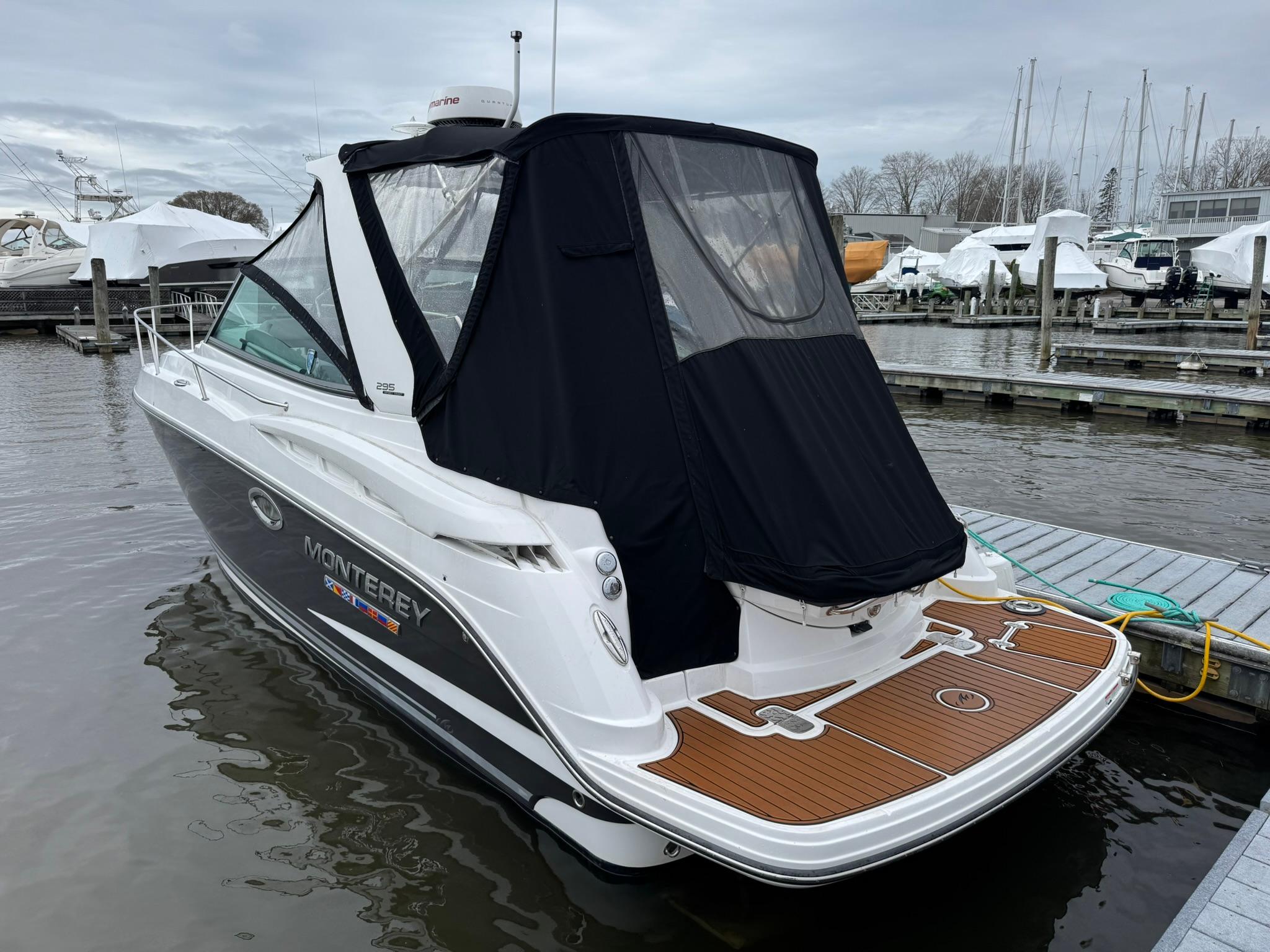 2020 Monterey 295 Sport Yacht docked, featuring sleek design and covered cockpit.