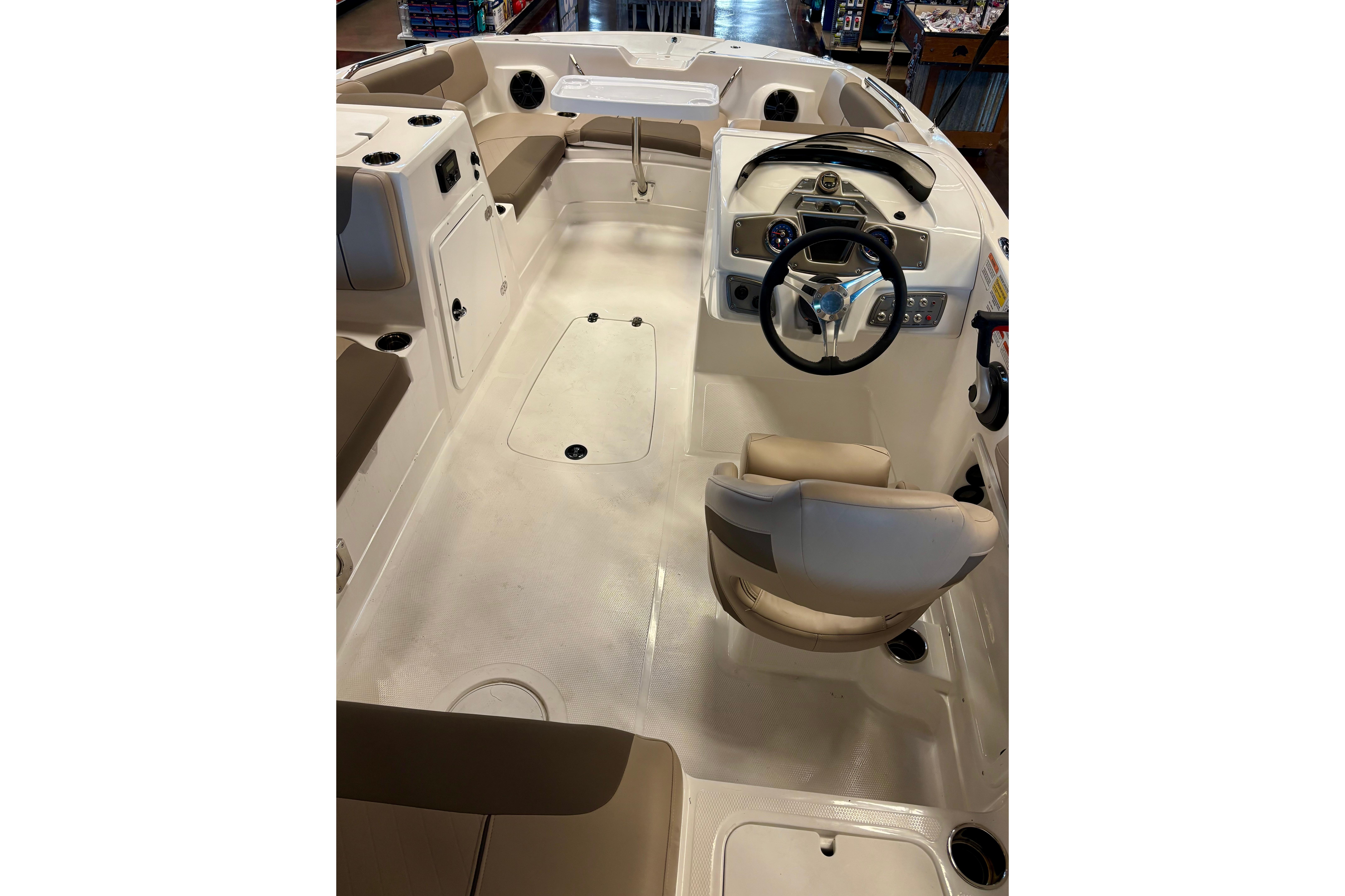 2026 Tahoe 2150 boat interior with beige seating and modern steering console.
