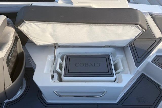 2023 Cobalt R6 Surf boat interior with open storage compartment.