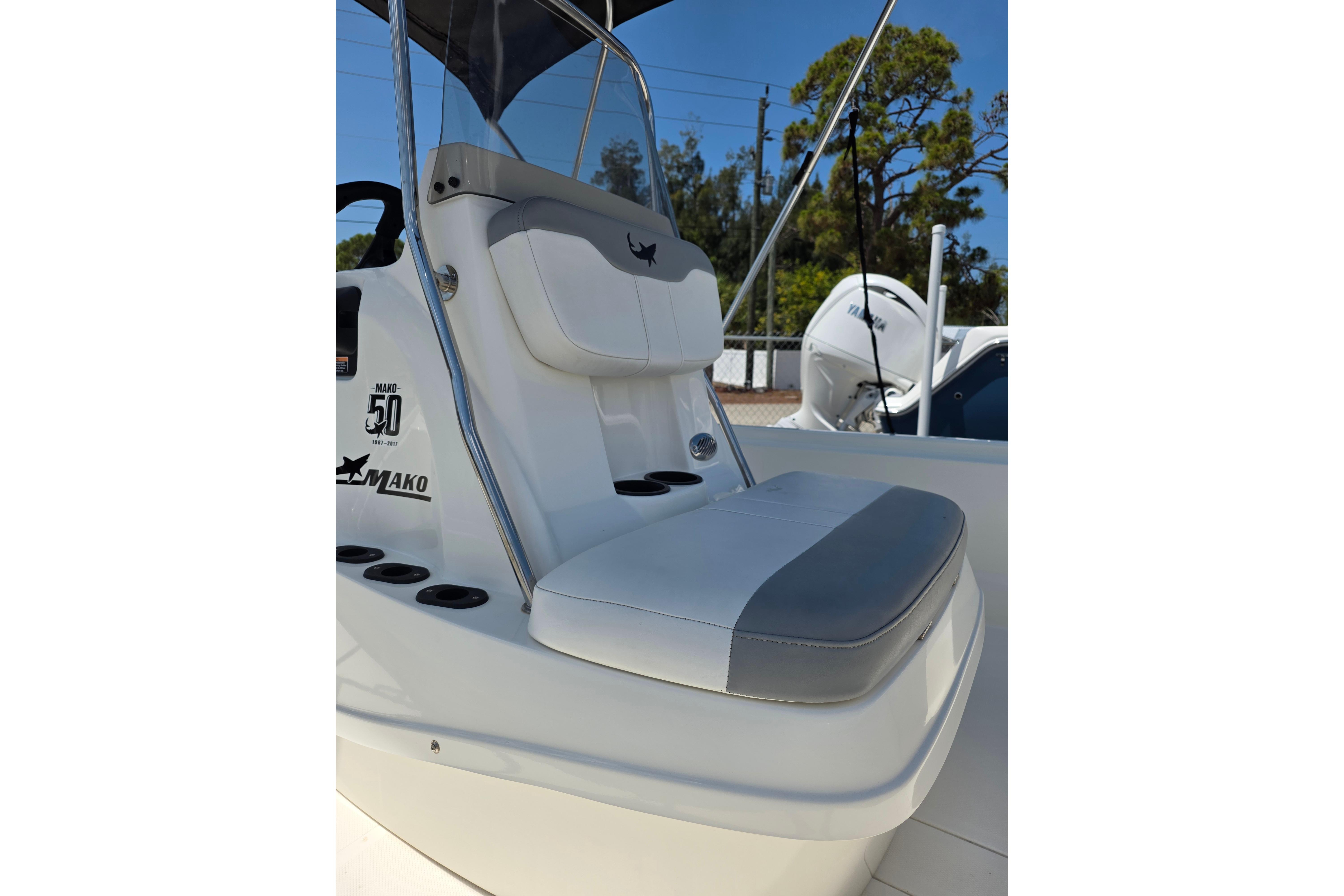 2018 Mako Pro Skiff 19 CC boat interior with cushioned seating and console details.