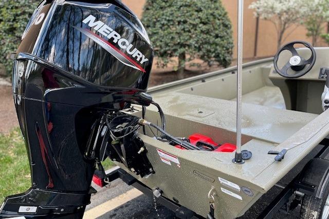 2026 Tracker Grizzly 1648 SC boat with Mercury outboard motor, parked outdoors.