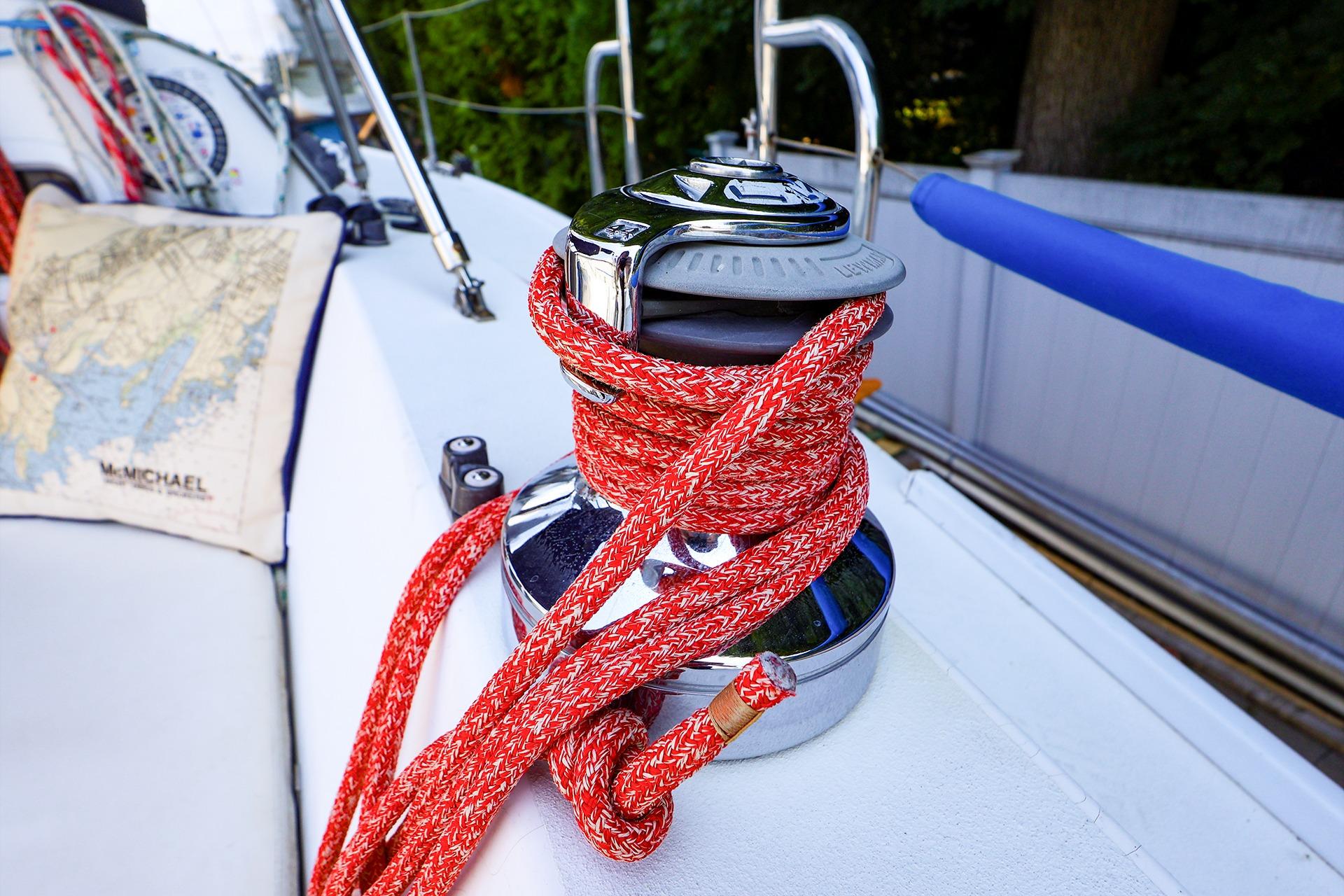 Red rope wrapped around a winch on a 2001 J Boats J/32 sailboat deck.