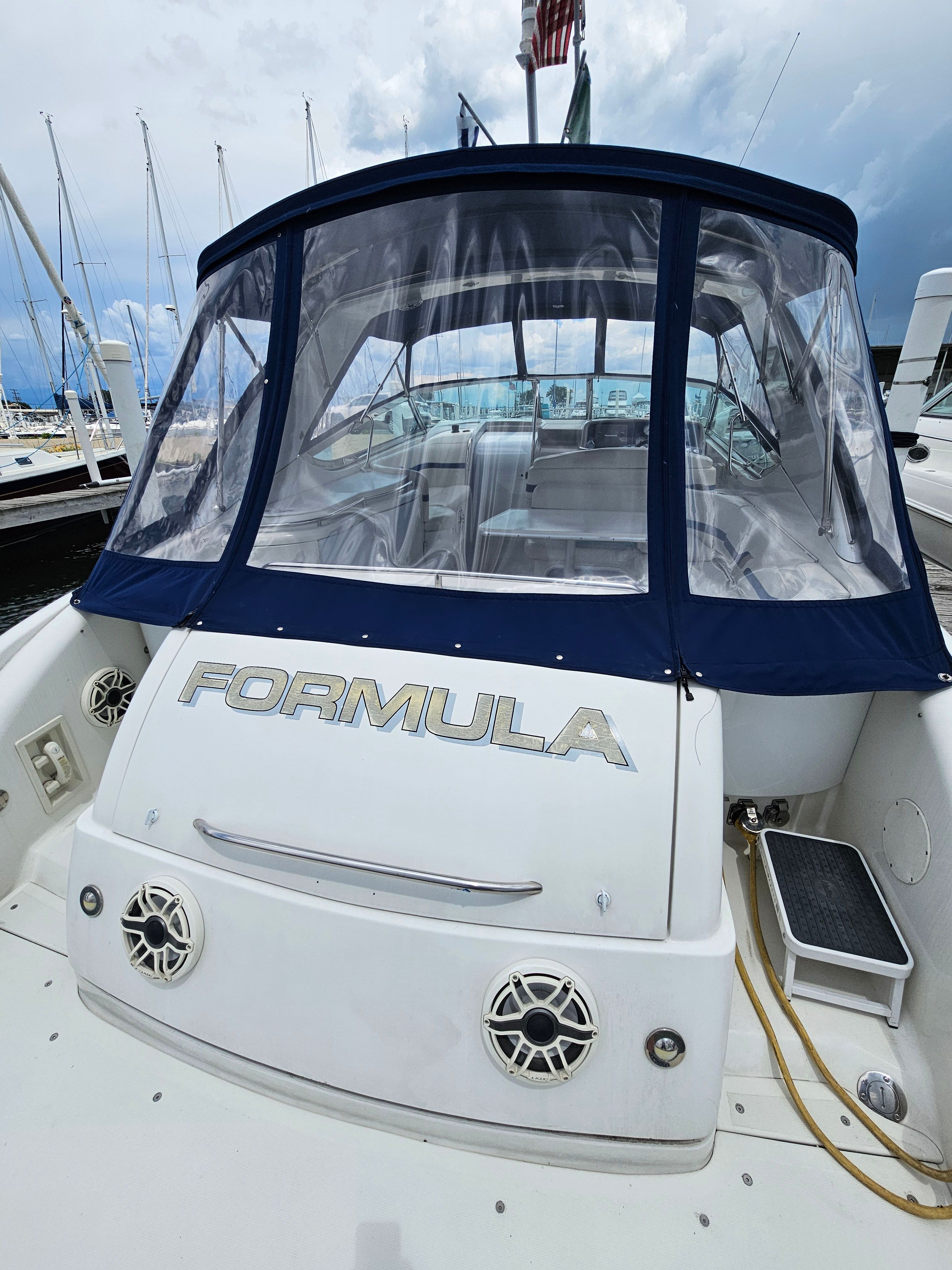 The image shows a boat with "Formula" on the back. It has a blue canopy.
