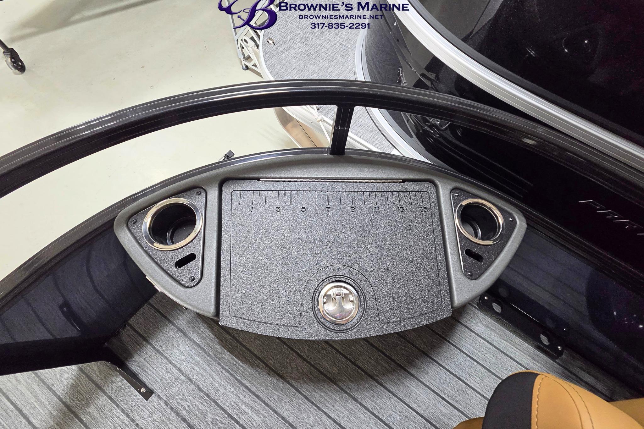 Dashboard of a 2026 Ranger 220F boat with cup holders and measurement markings.