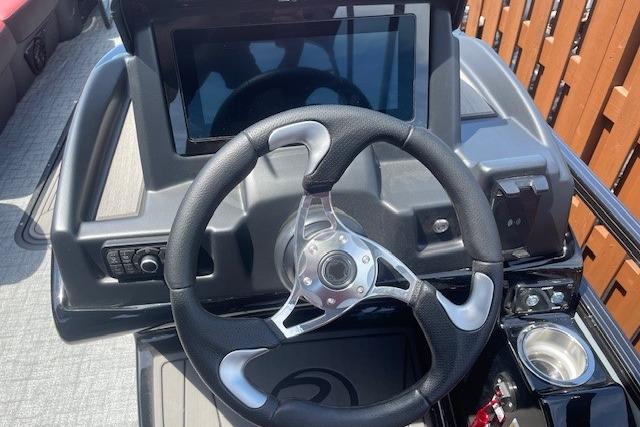 Steering wheel and dashboard of 2026 Regency 250 DL boat, featuring modern controls and display.