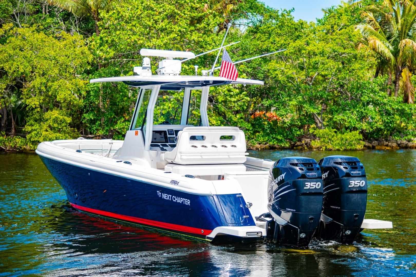 2018 Intrepid 327 Center Console boat with dual Mercury engines on a scenic waterway.