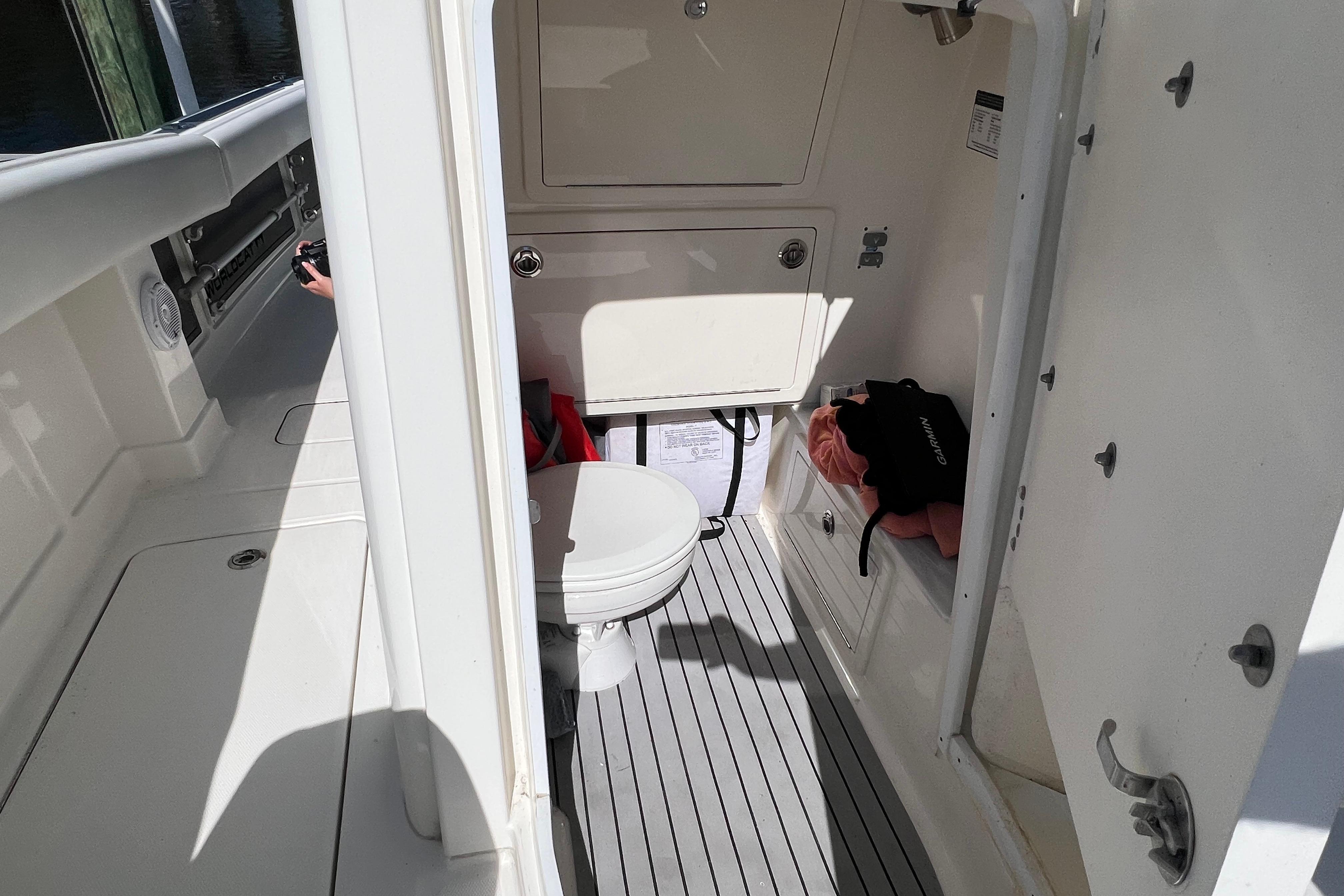 2022 World Cat 280 CC-X boat interior with compact bathroom and storage.