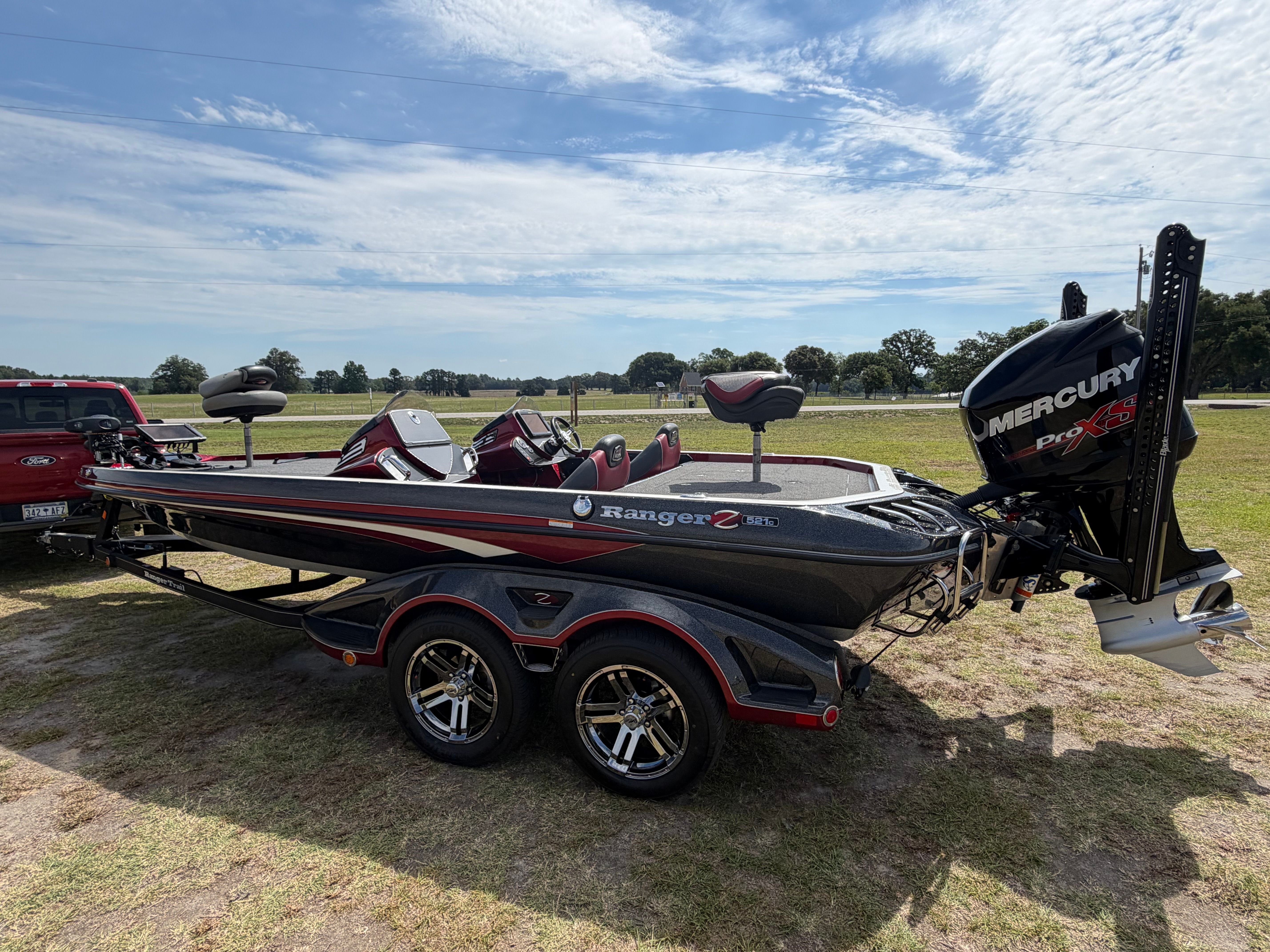A 2018 Ranger 521C boat on a trailer parked on grass.