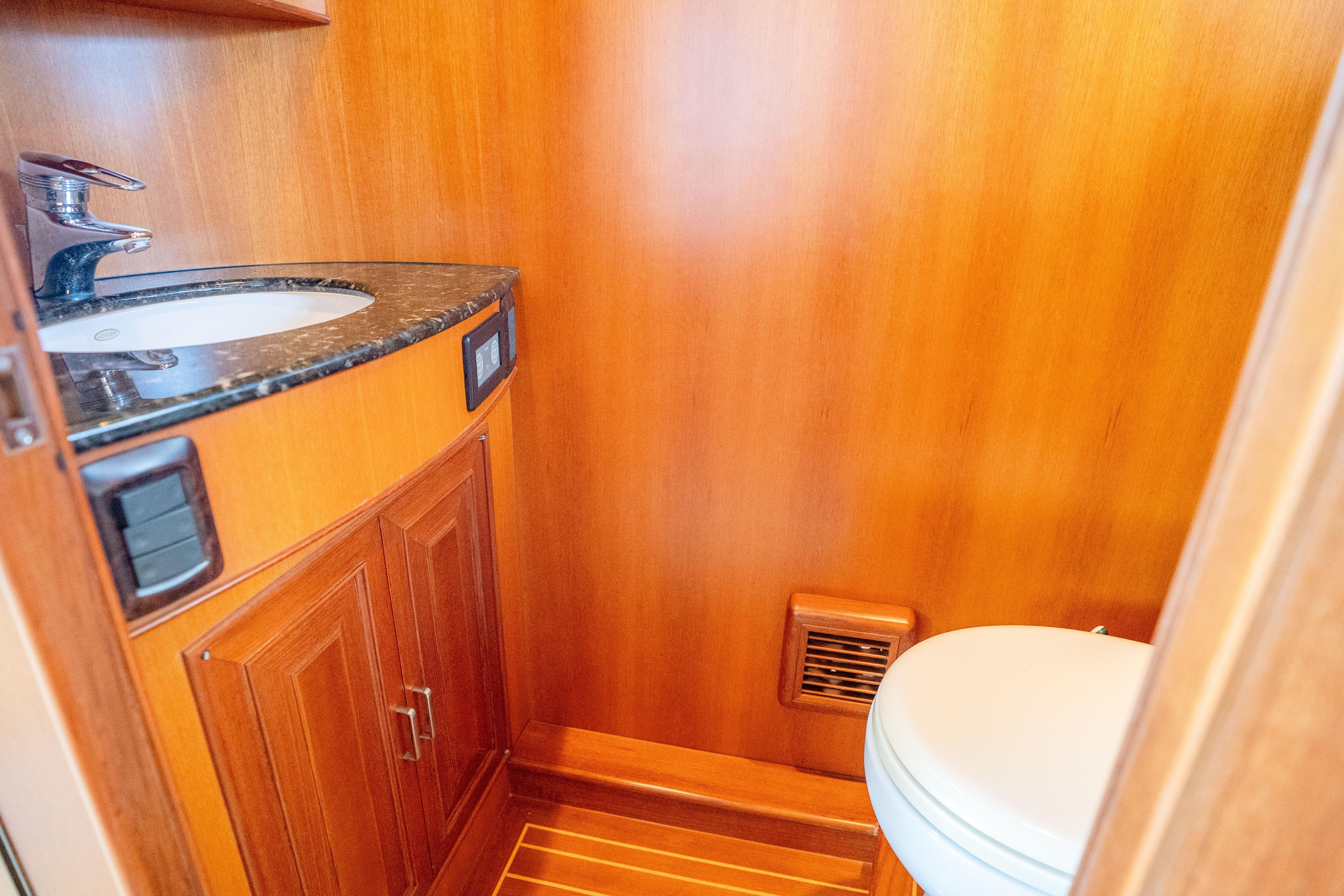 Luxurious wooden bathroom interior on a 2006 Fleming 75 yacht.