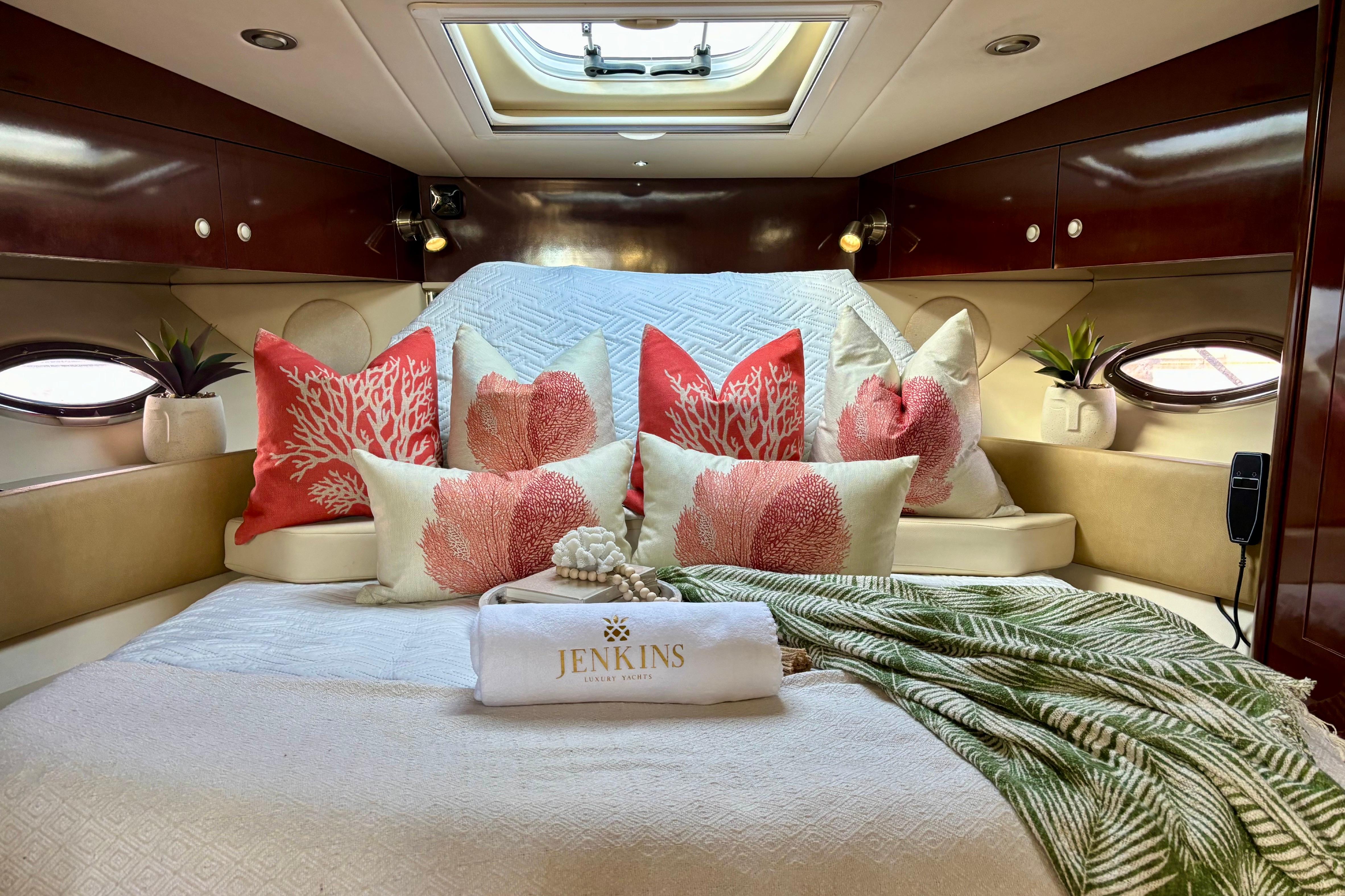 Luxurious cabin interior of 2009 Sea Ray Sundancer 350 yacht with coral-themed decor.