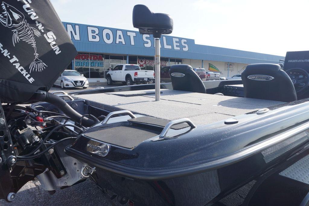 2025 Phoenix 921 Elite boat at dealership, showcasing deck and seating.