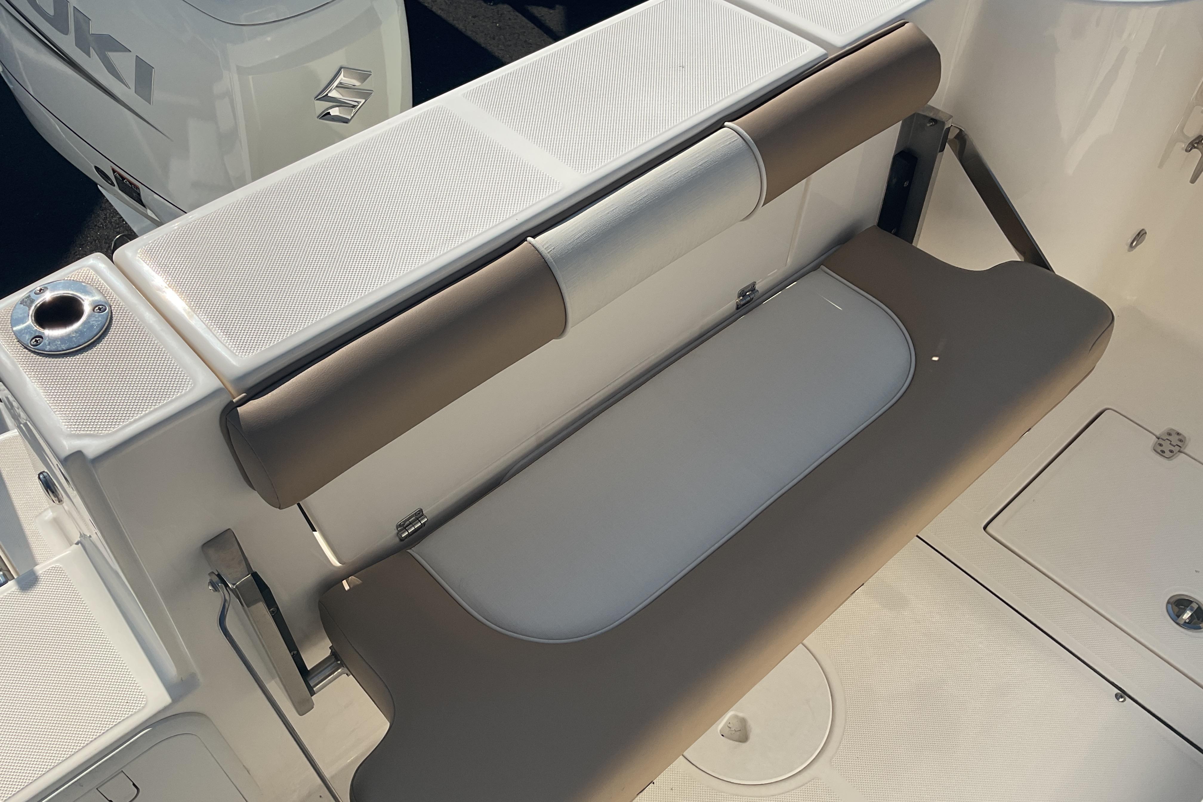 2023 Sea Born SX239 Offshore boat seating area with Suzuki engine in background.