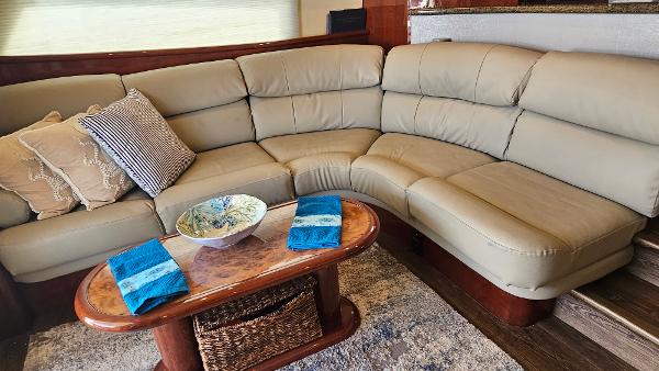 Luxurious Neptunus 56 Flybridge 2005 yacht interior with beige leather seating and elegant decor.