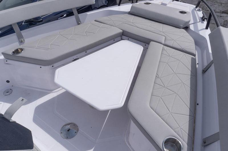 2025 Axopar 29 XC Cross Cabin interior with cushioned seating and table.