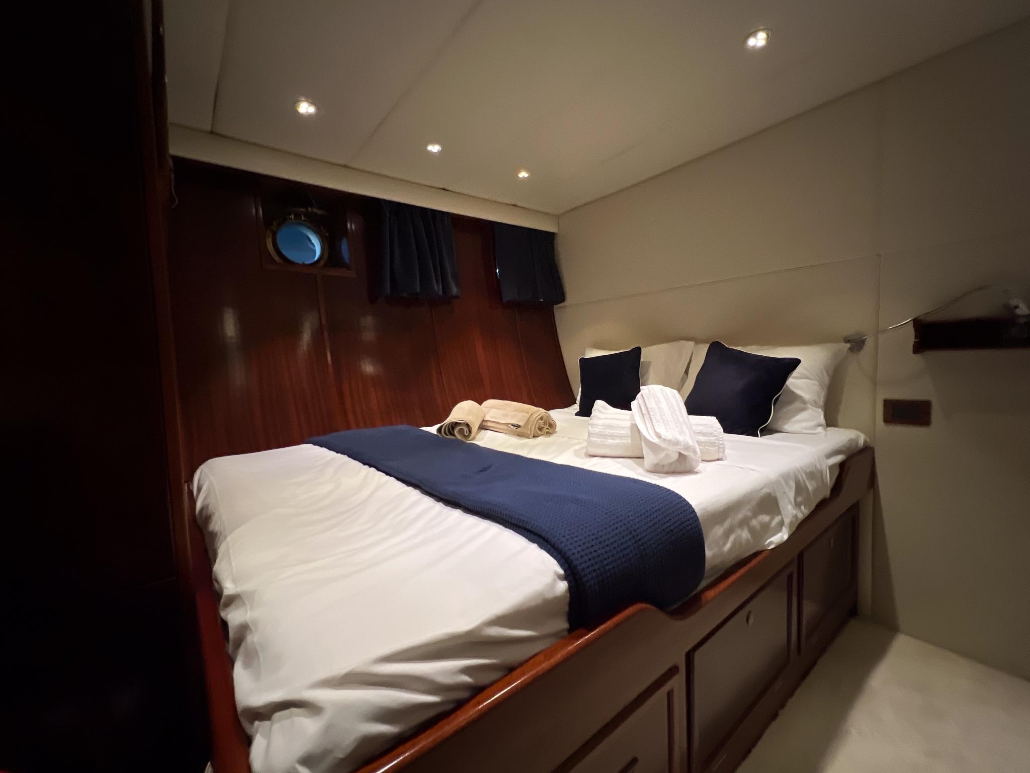 Luxurious cabin interior on a 1969 Psarros Shipyard custom yacht, featuring a cozy bed.