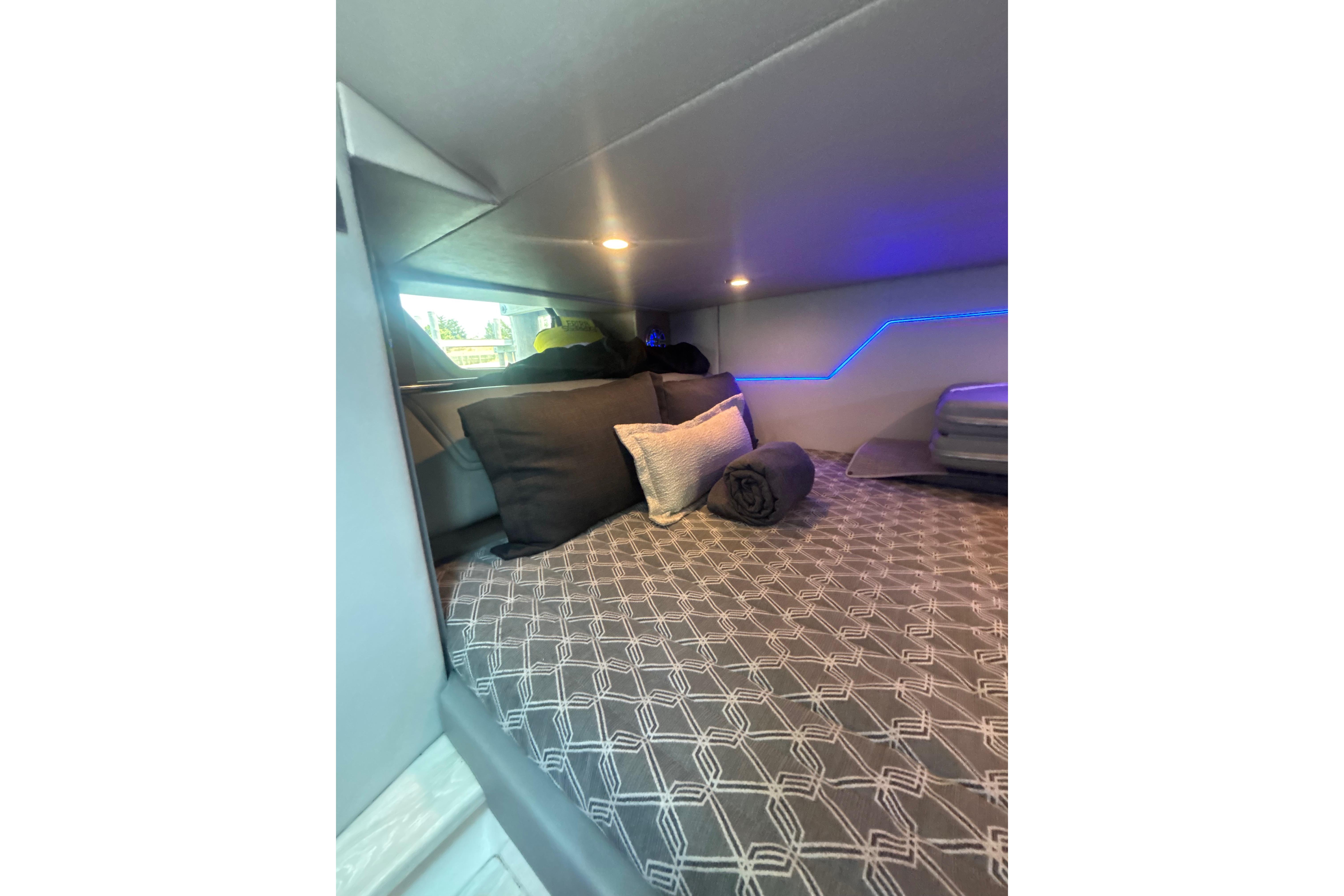 Cozy cabin interior of 2019 Formula 430 Super Sport Crossover with modern bedding and ambient lighting.