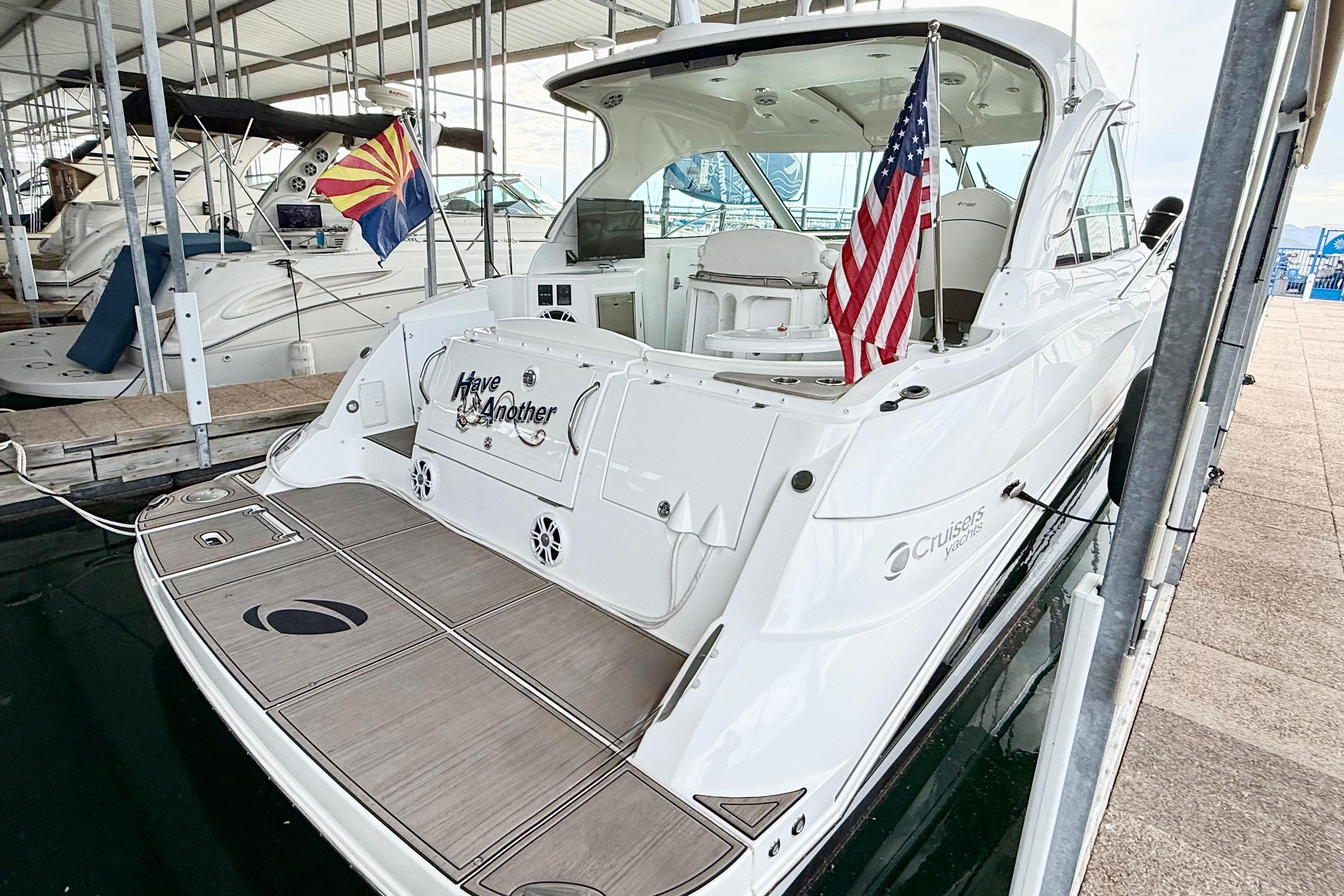 2011 Cruisers Yachts 390 Sports Coupe docked with flags displayed.