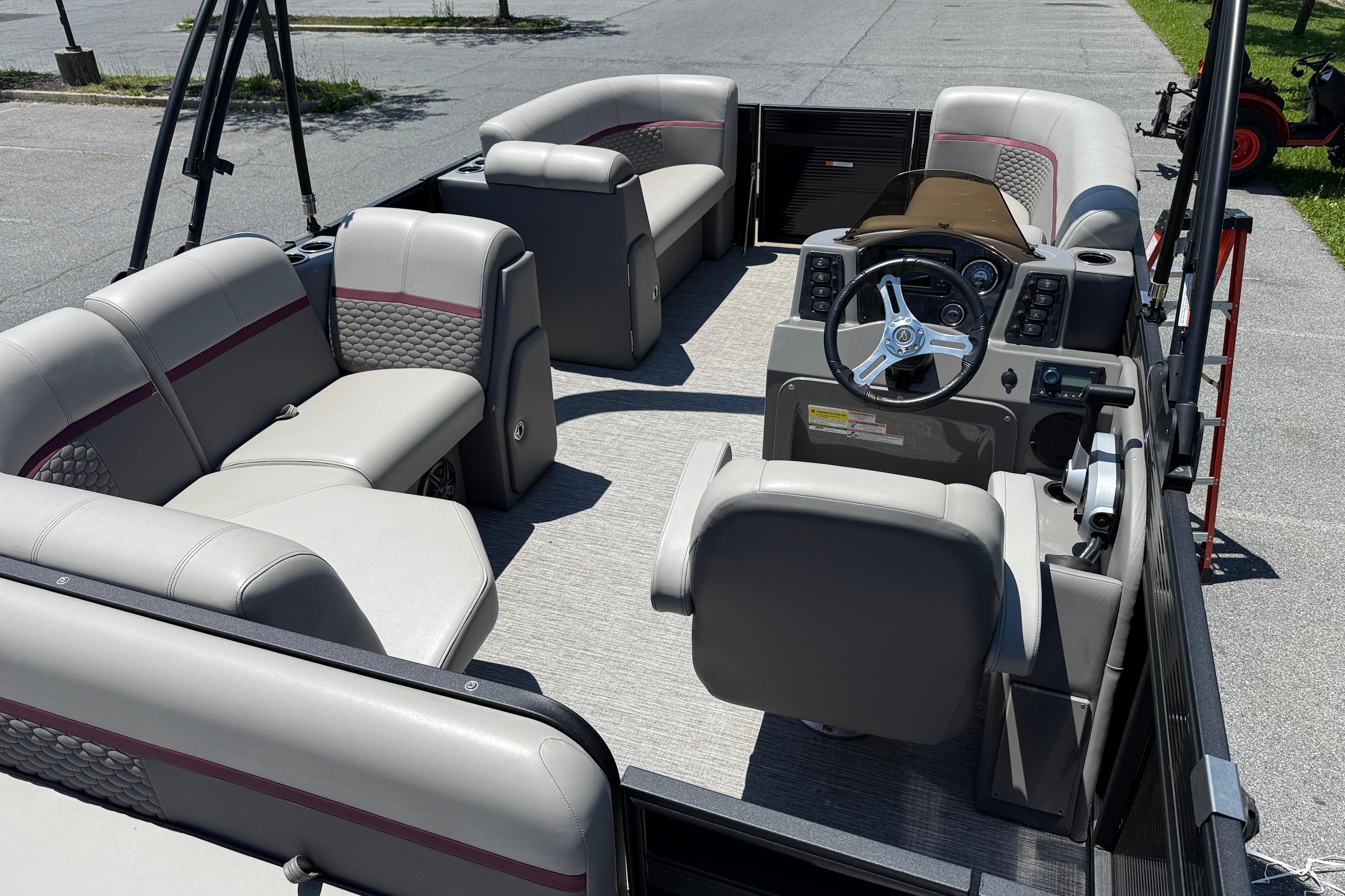 2023 Apex 818 pontoon boat interior with plush seating and modern steering console.