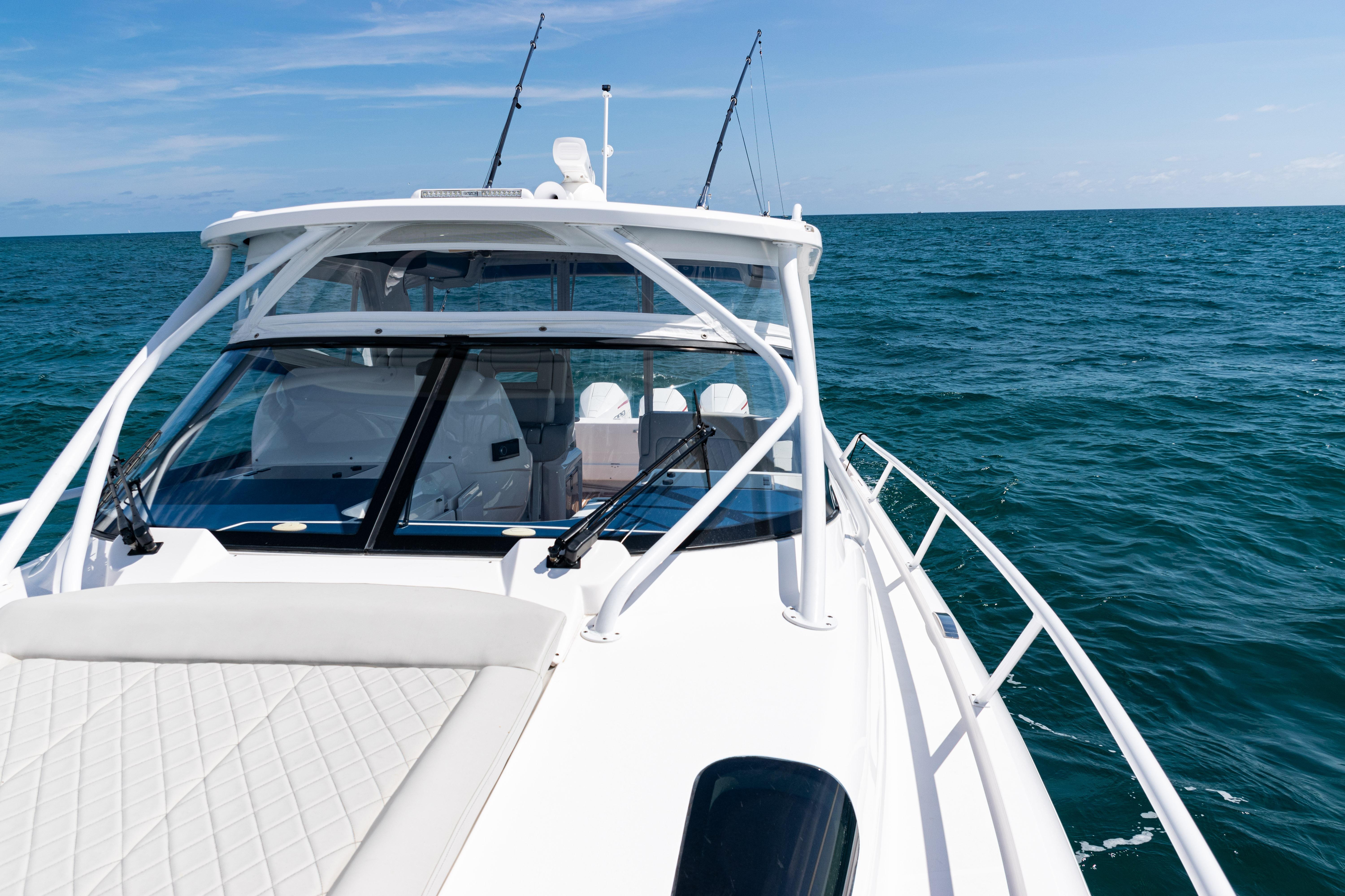 2018 Intrepid 438 Evolution yacht cruising on open sea under clear skies.