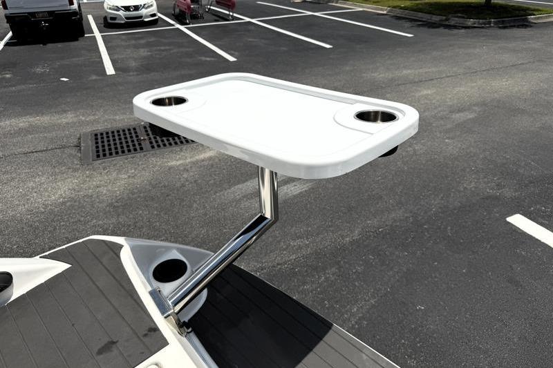 2017 Yamaha Boats SX210 with a mounted table in a parking lot.