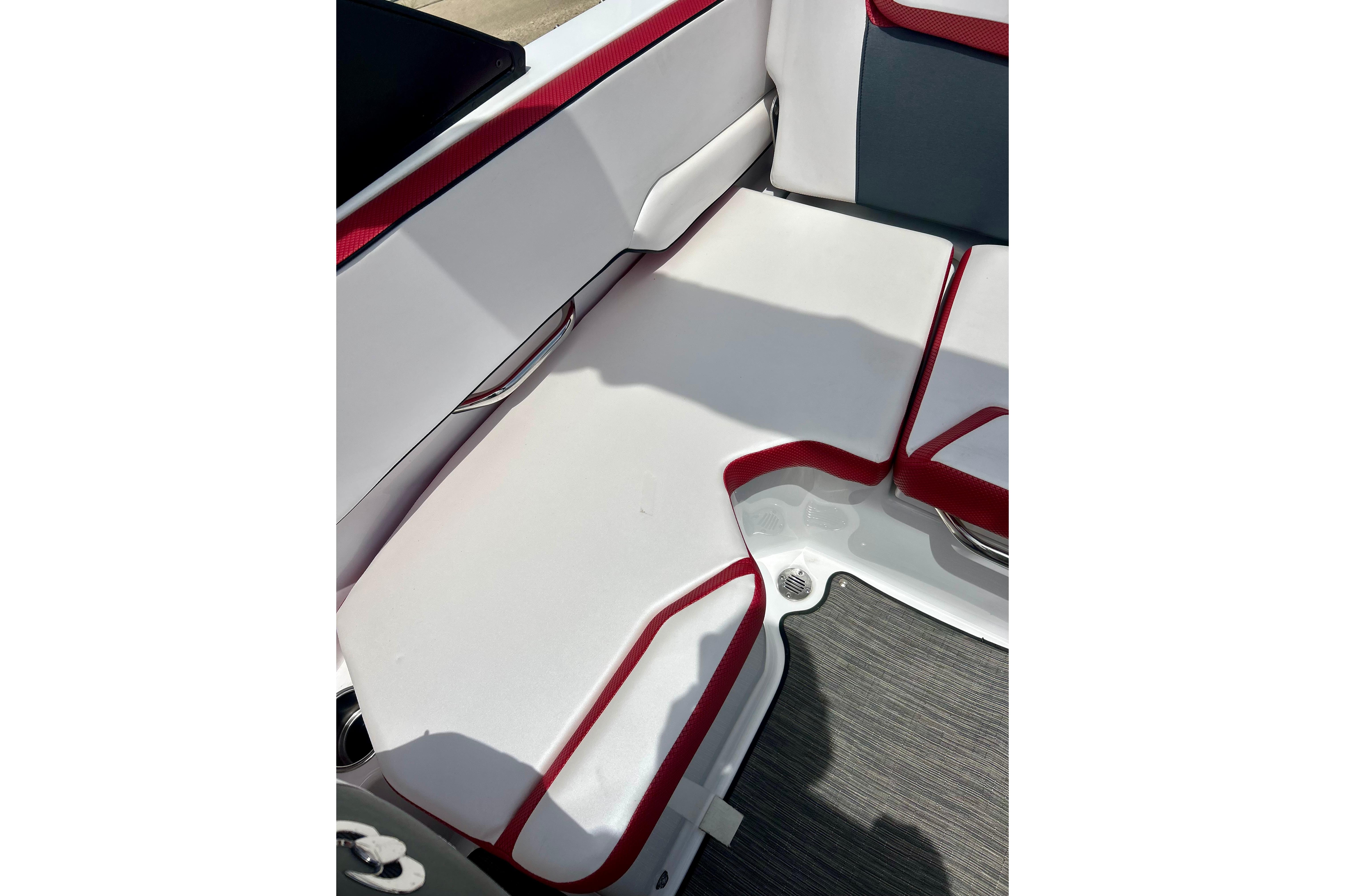 Interior seating of 2021 Scarab 195 ID boat with red and white upholstery.