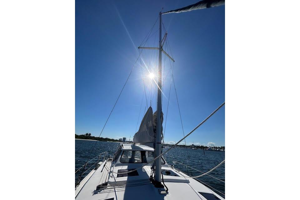 Sailing on a 2013 Gemini Legacy boat under clear blue skies.