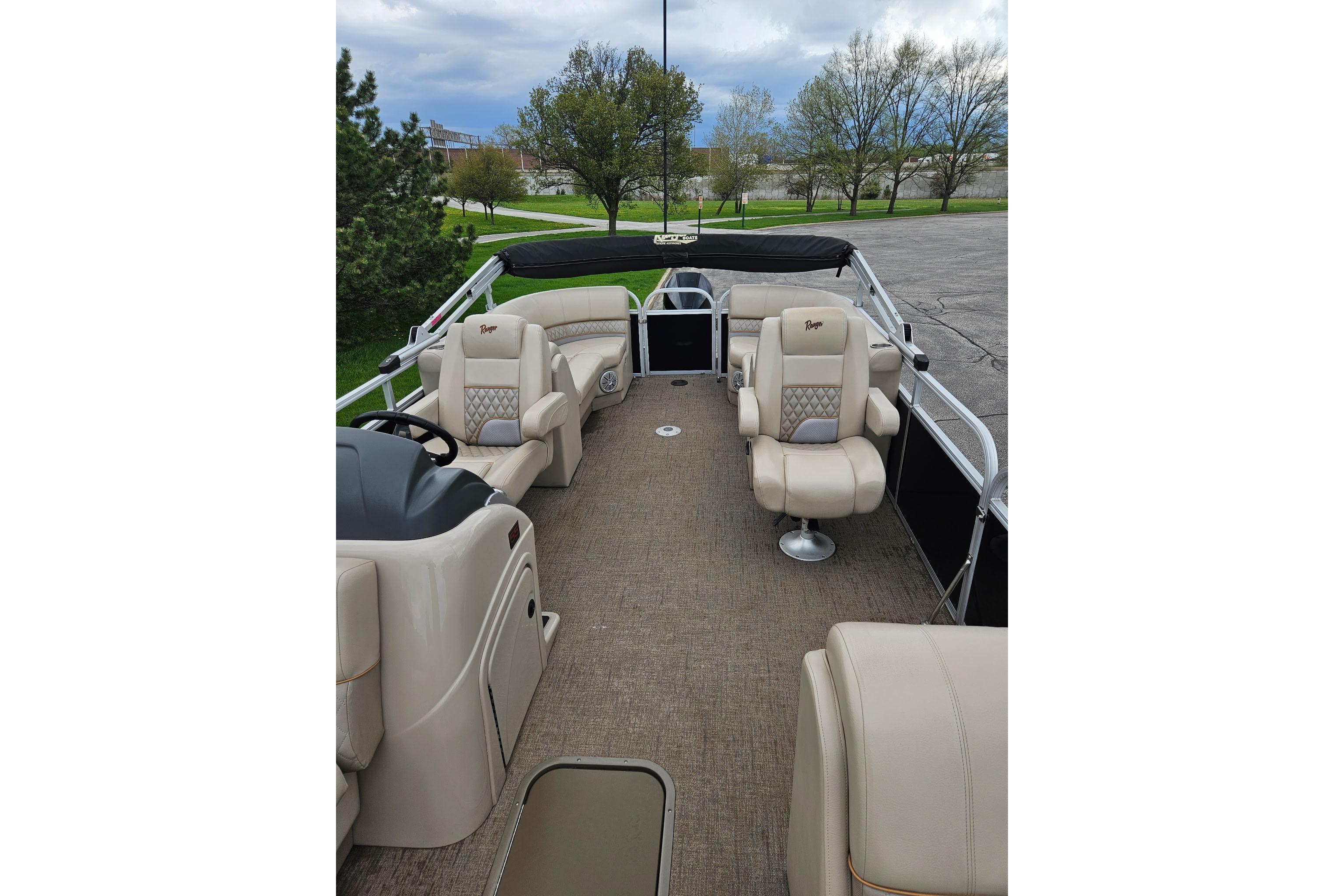 2023 Ranger Reata 243C pontoon boat interior with beige seating and open deck.