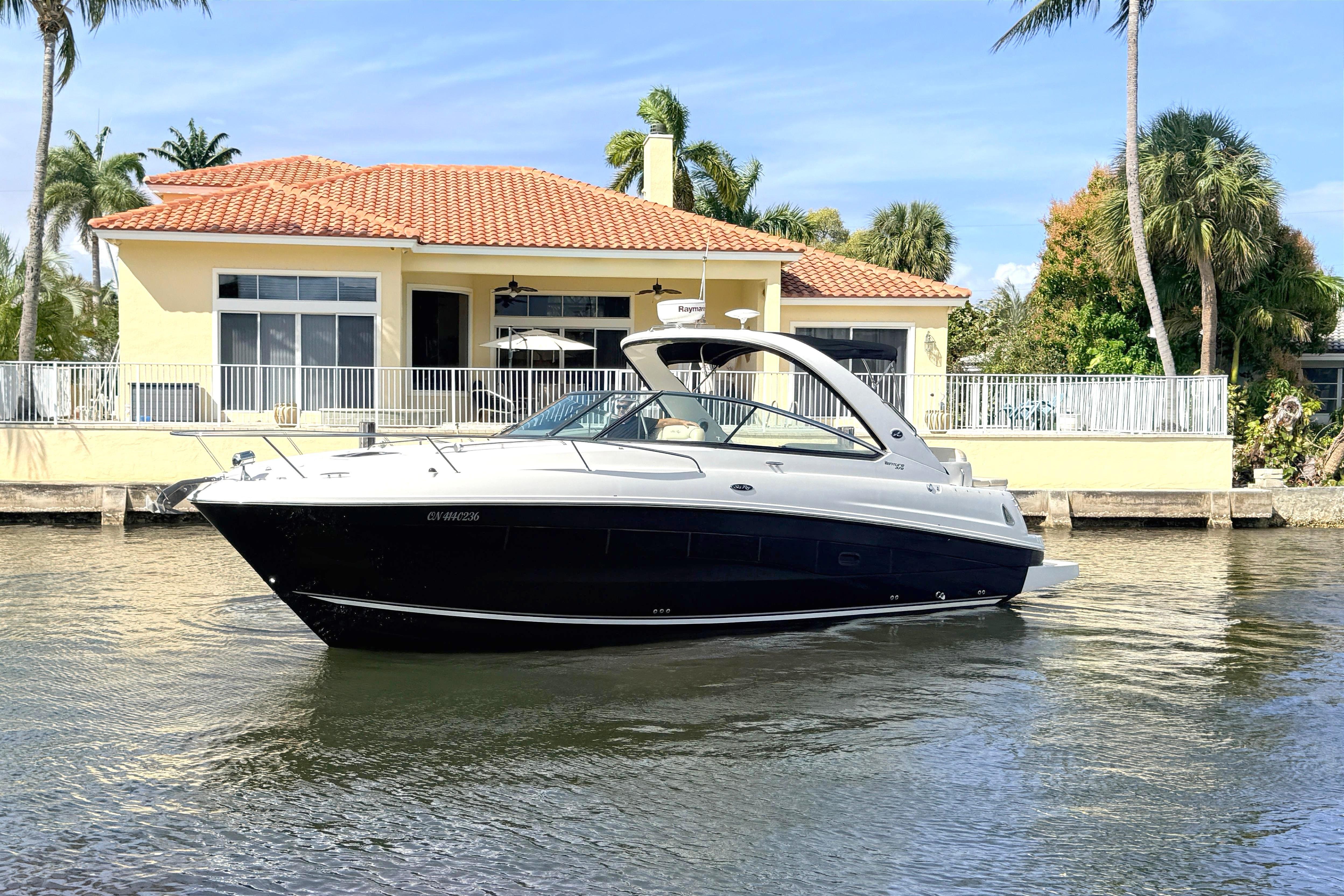 2013 Sea Ray 370 Venture yacht in front of waterfront house.