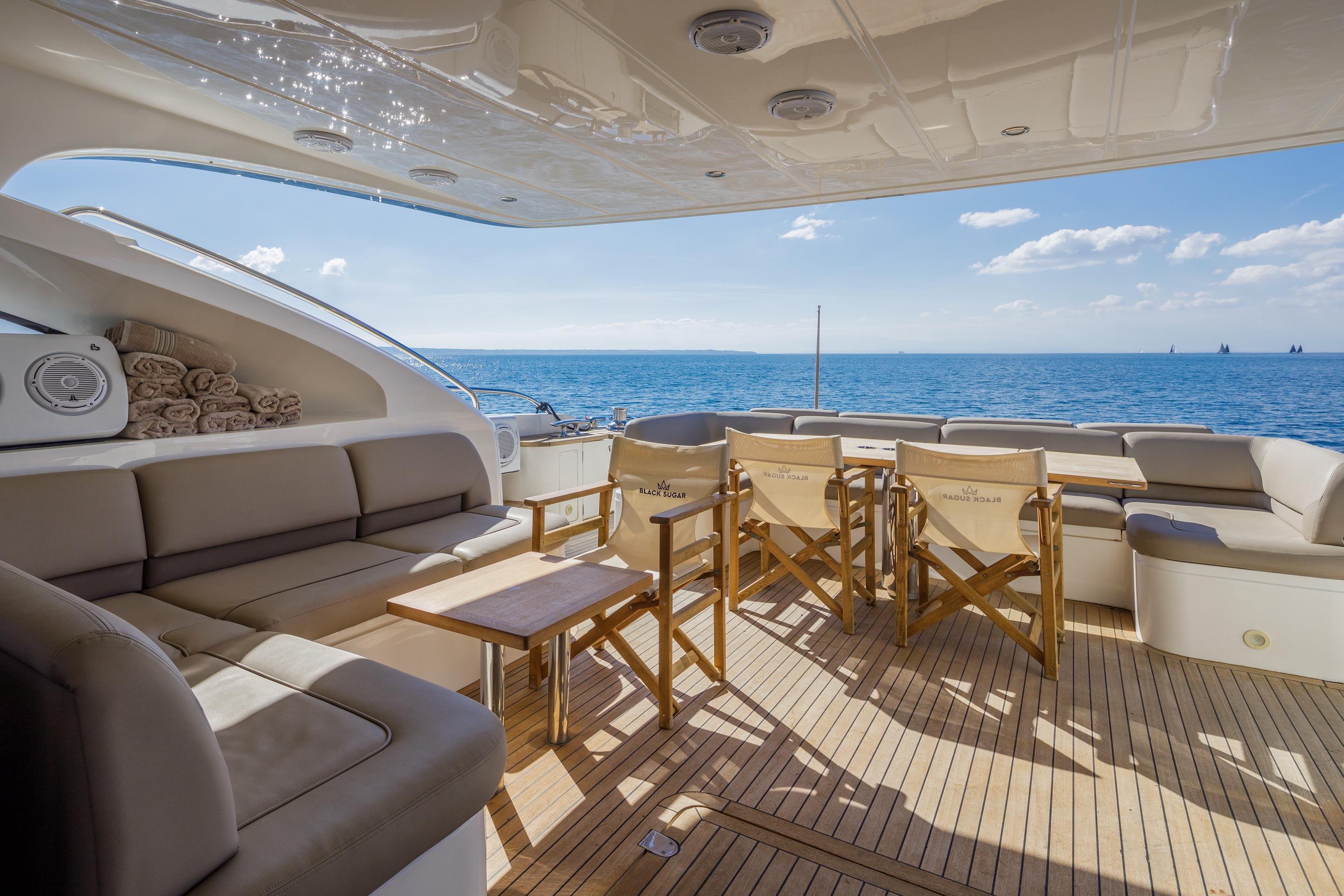 Luxurious 2010 Princess V78 yacht deck with seating, ocean view, and clear skies.